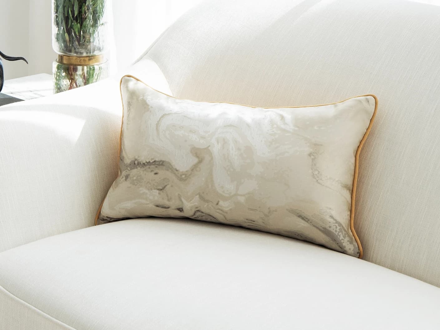 Mae Klimt single cushions in silver and yellow, shown in a lifestyle front view