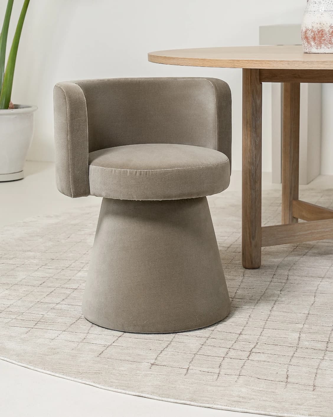 Mara Alpaca swivel chair in brown, shown in a lifestyle left view as image 2