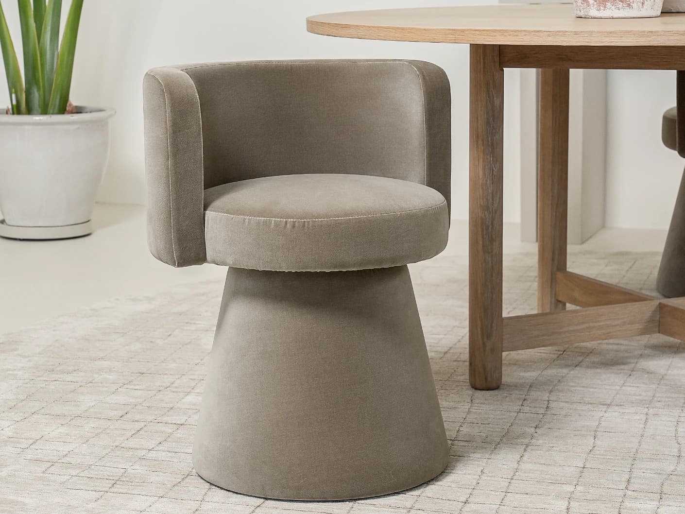 Mara Alpaca swivel chair in brown, shown in a lifestyle left view as image 3