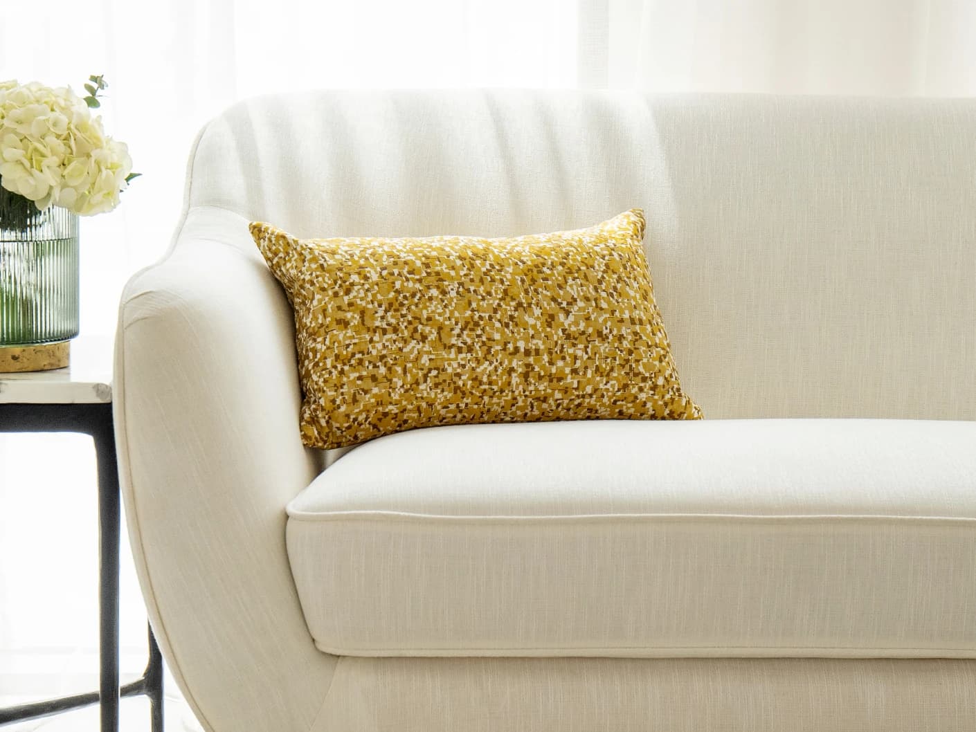 Marigold Klimt single cushions in gold and yellow, shown in a lifestyle front view