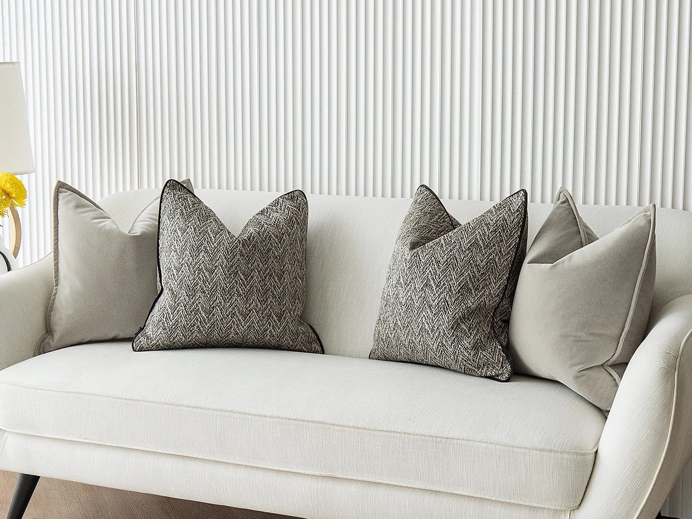 Marilee Bundle bundle cushions in brown, grey and black, shown in a lifestyle front view