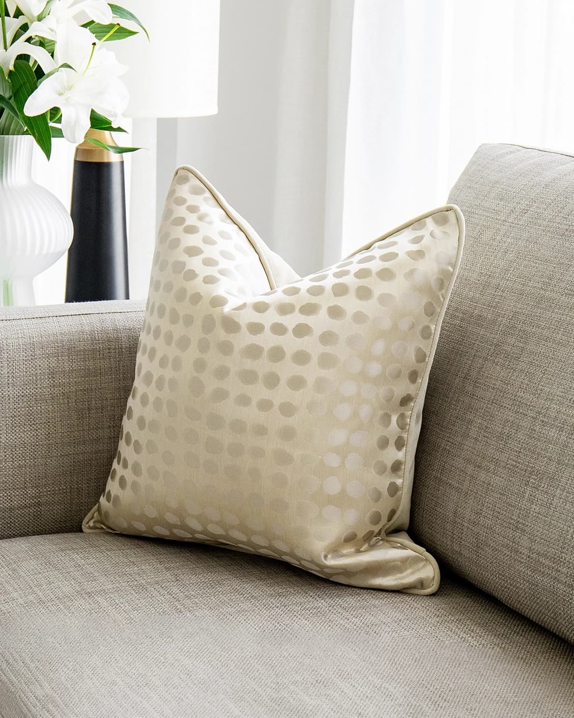 Marissa Bianca cushion in beige and silver, shown in a lifestyle front view as image 2