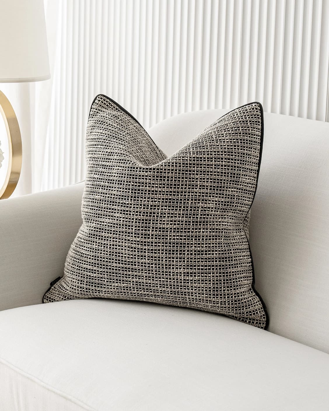 Marlee Steele cushion in black, shown in a lifestyle front view as image 2