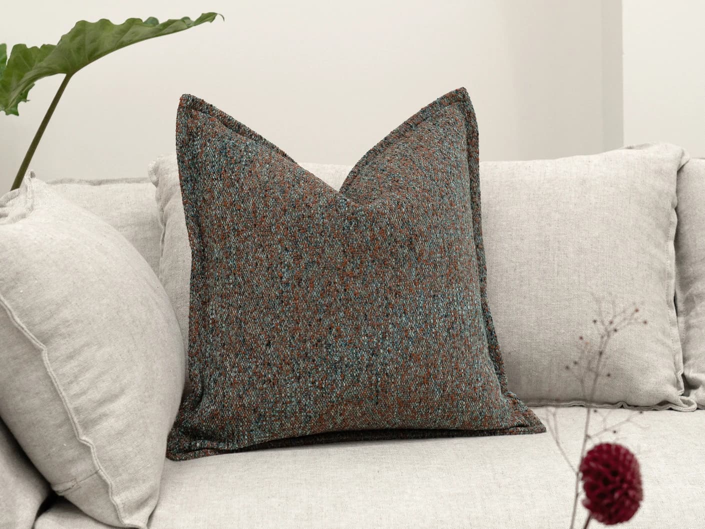 May Chromix single cushions in blue and multicolour, shown in a lifestyle front view