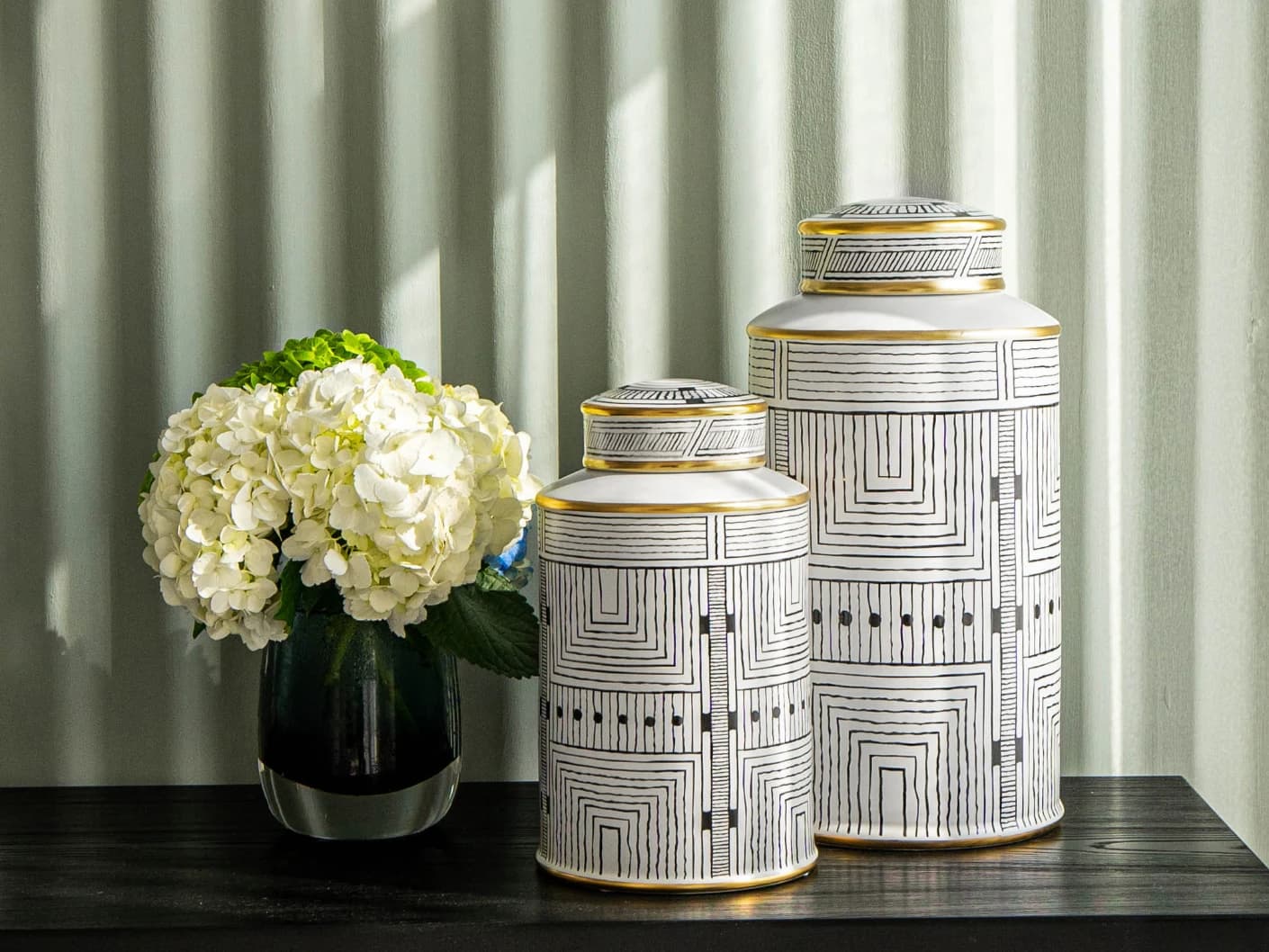 Maze Arneson canisters in black and white, shown in a lifestyle front view