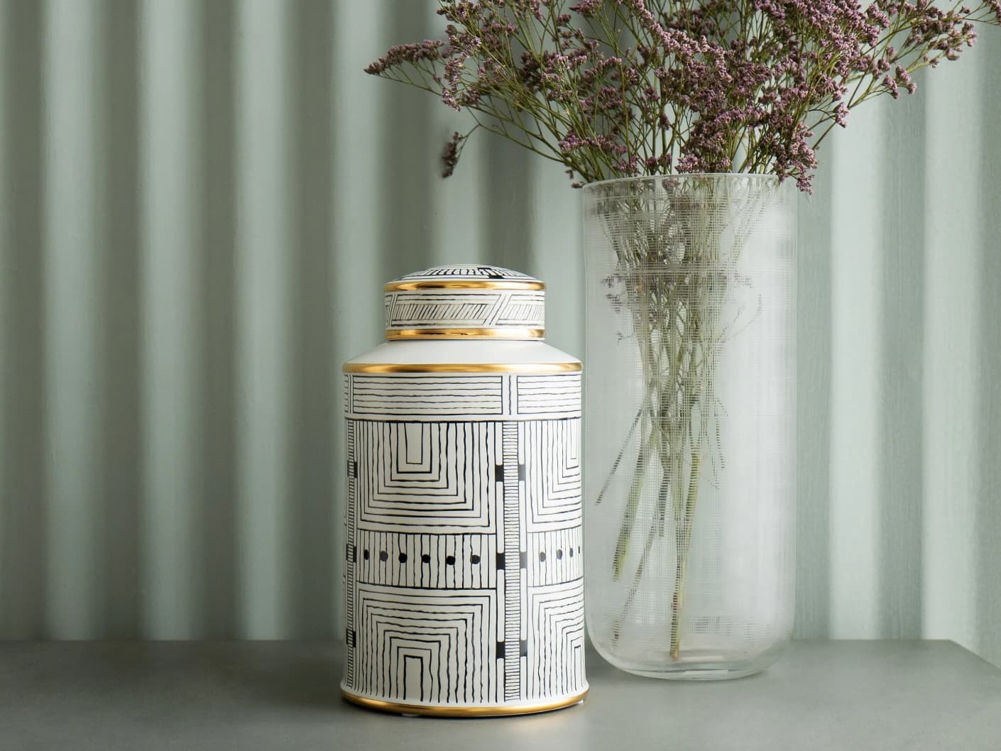 Maze Arneson II canisters in black and white, shown in a lifestyle front view