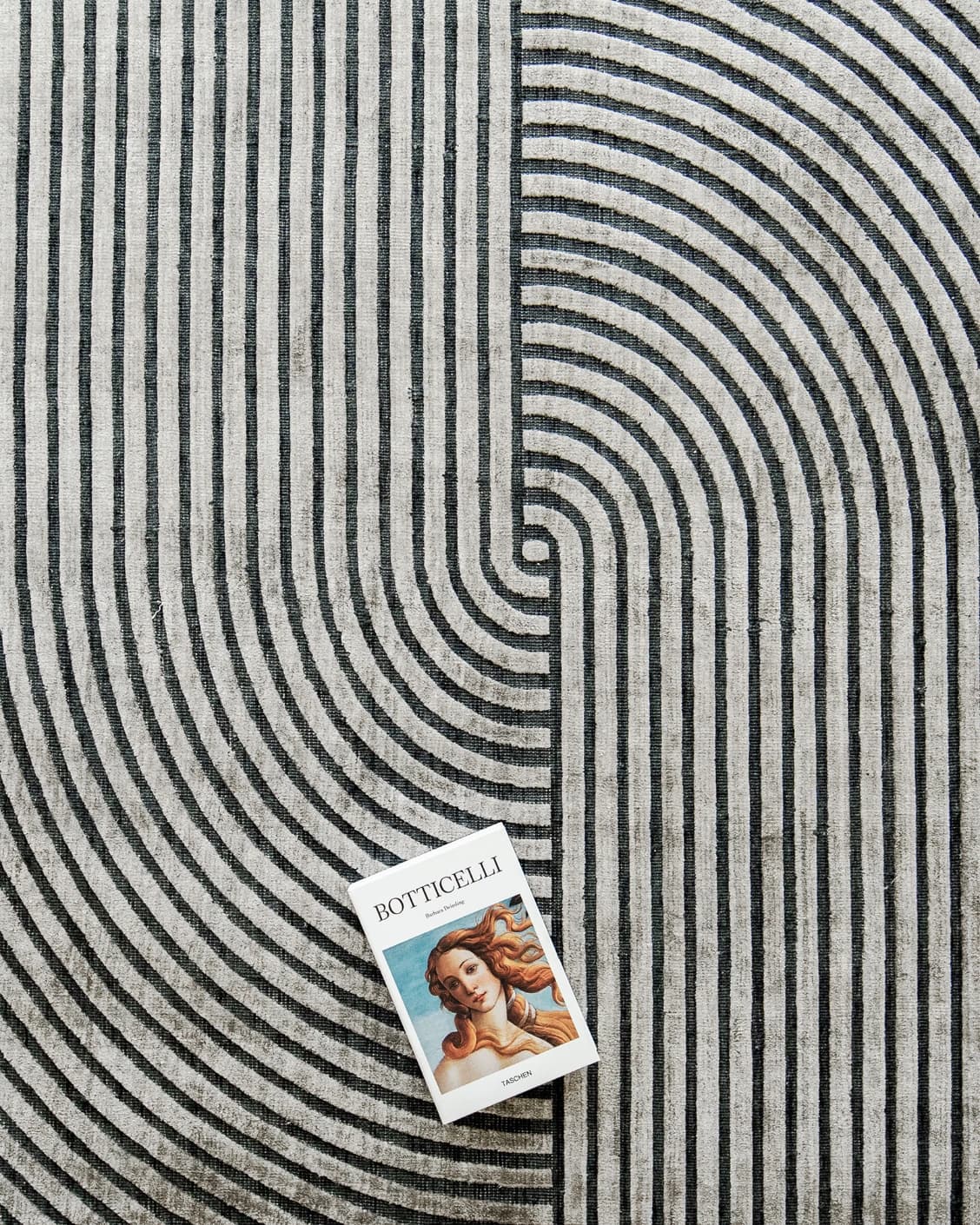 Maze Ebony carpet in grey and charcoal, shown in a lifestyle top view as image 6