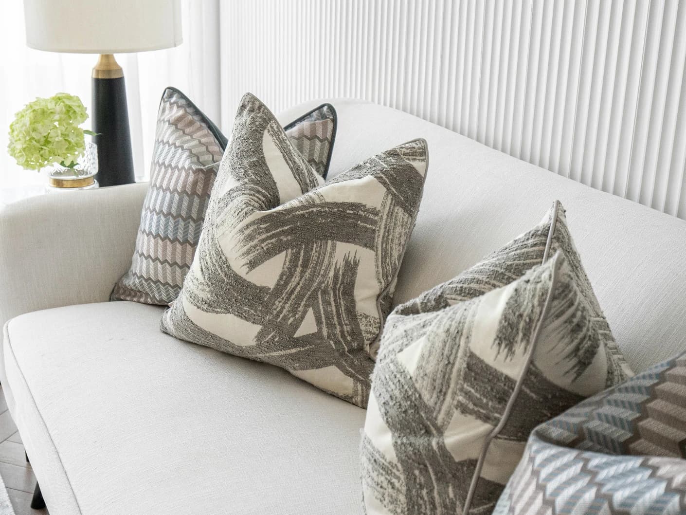 Meadow Bundle bundle cushions in silver, blue, white and grey, shown in a lifestyle front view