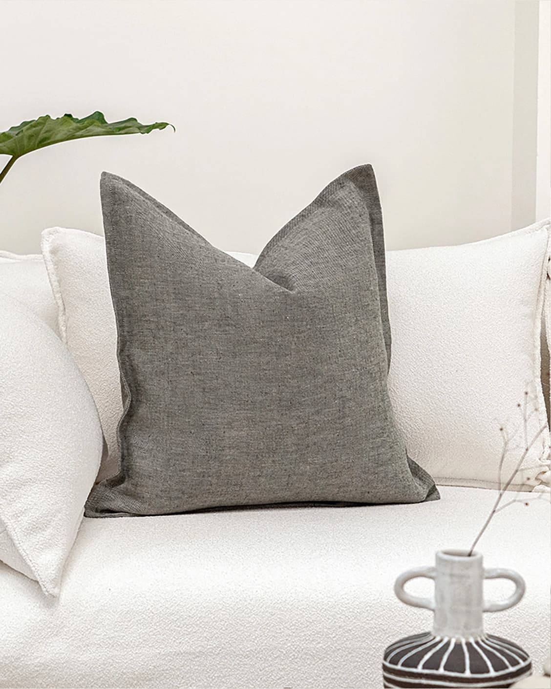 Mel Ash cushion in grey, shown in a lifestyle front view as image 2