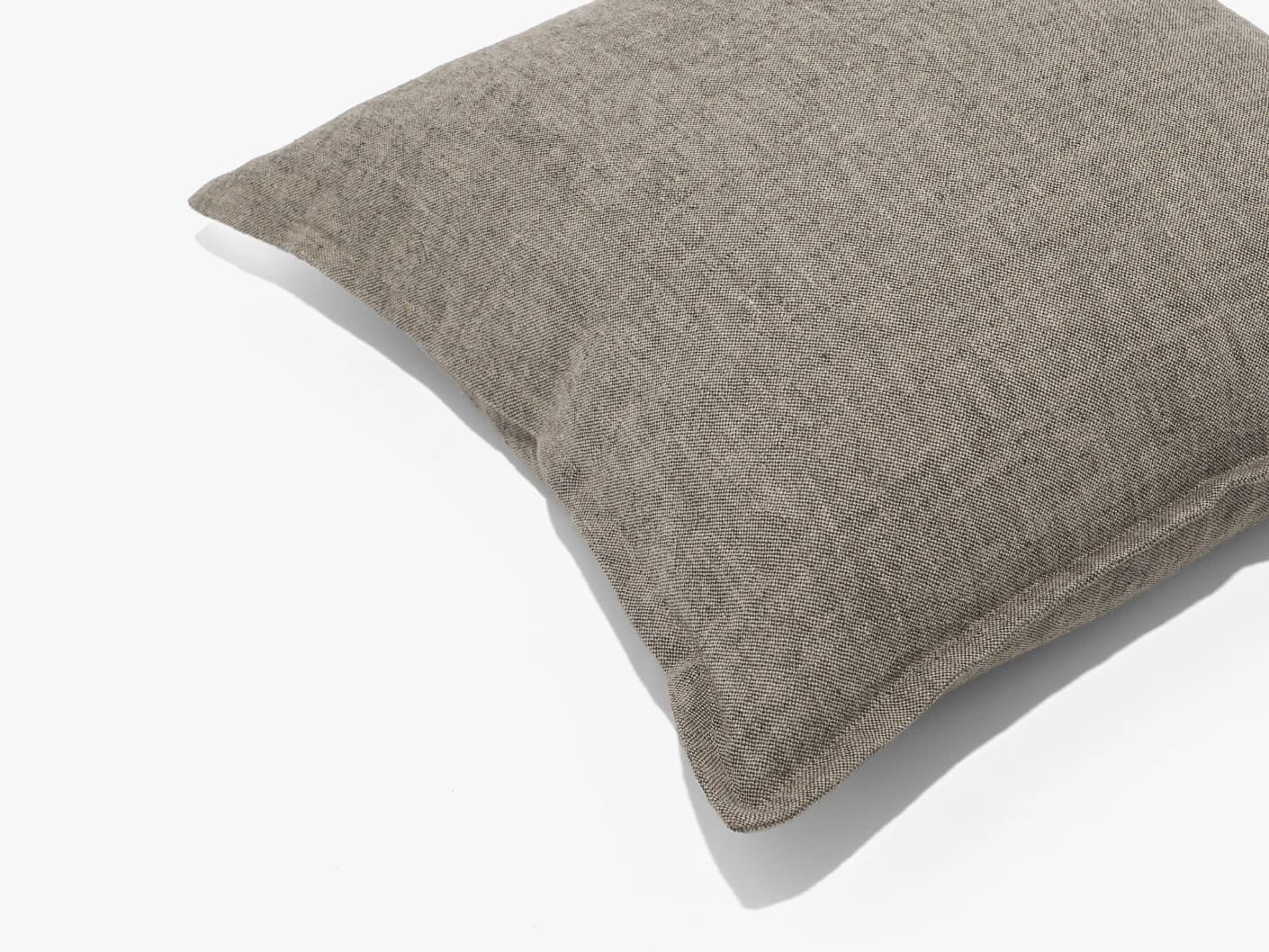 Mel Smoke cushion in linen, grey and charcoal, shown in a lifestyle front view as image 2