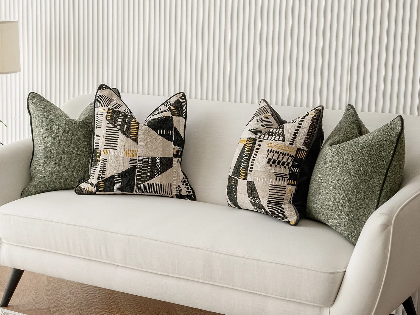 Melaina Bundle bundle cushions in green, black and beige, shown in a lifestyle front view