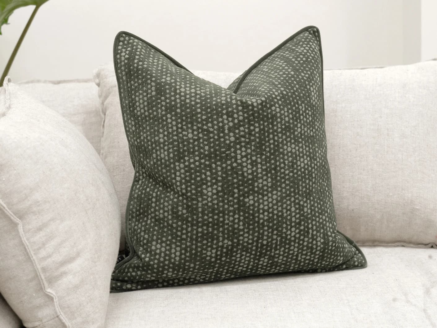 Mercy Sage single cushions in green, shown in a lifestyle front view