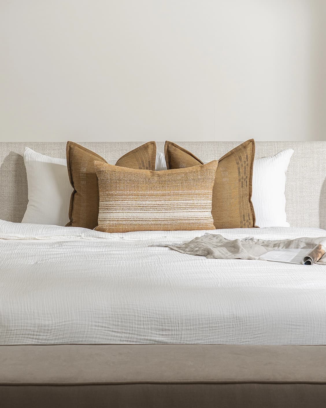 Mihi Bundle cushion in ochre and cream, shown in a lifestyle front view as image 2