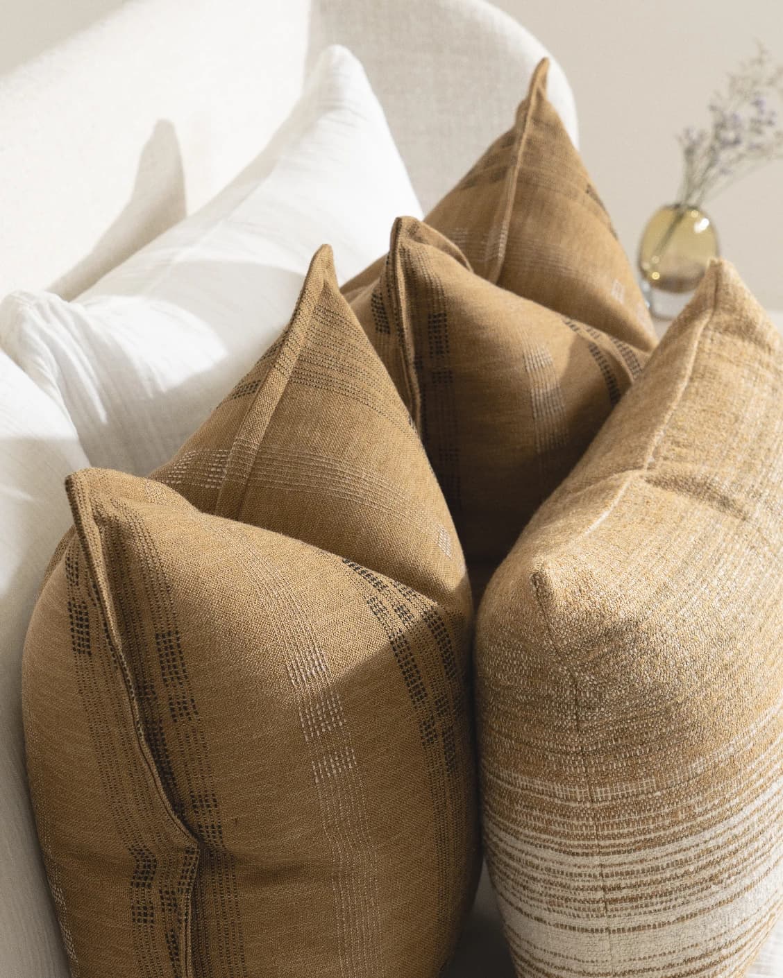 Mihi Bundle cushion in ochre and cream, shown in a lifestyle close-up left view as image 5