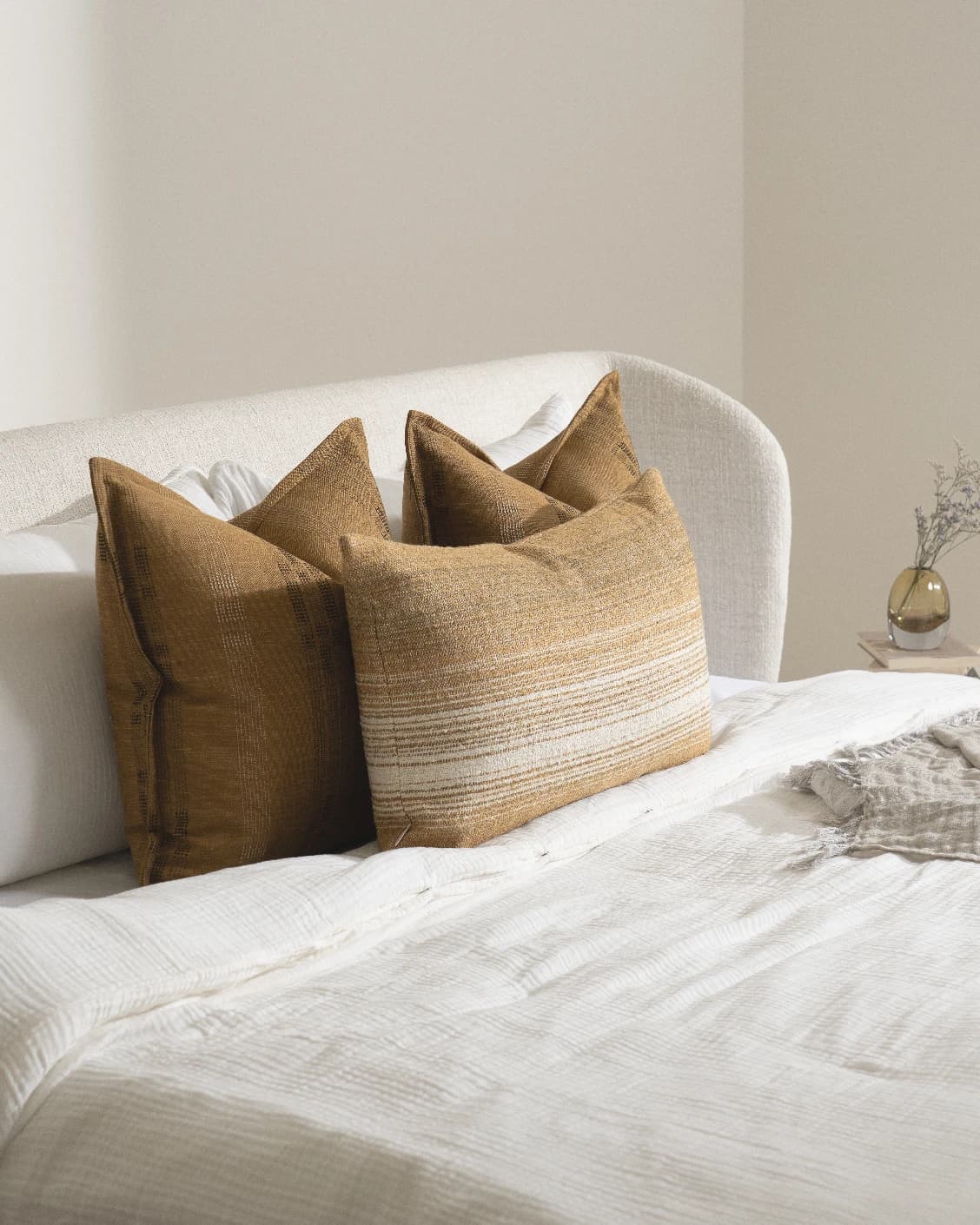 Mihi Bundle cushion in ochre and cream, shown in a lifestyle left view as image 6