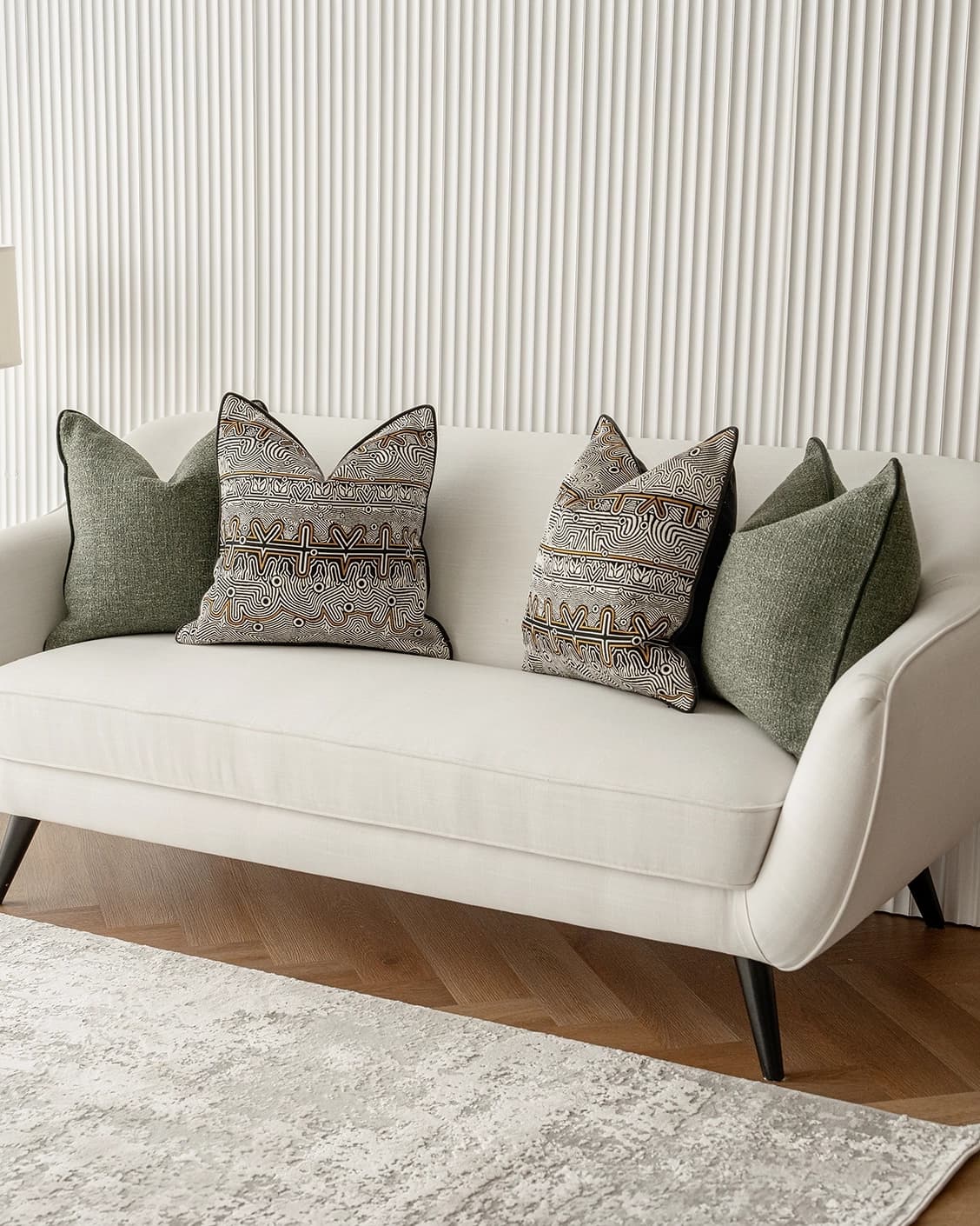 Mika Bundle cushion in black, silver and green, shown in a lifestyle right view as image 2