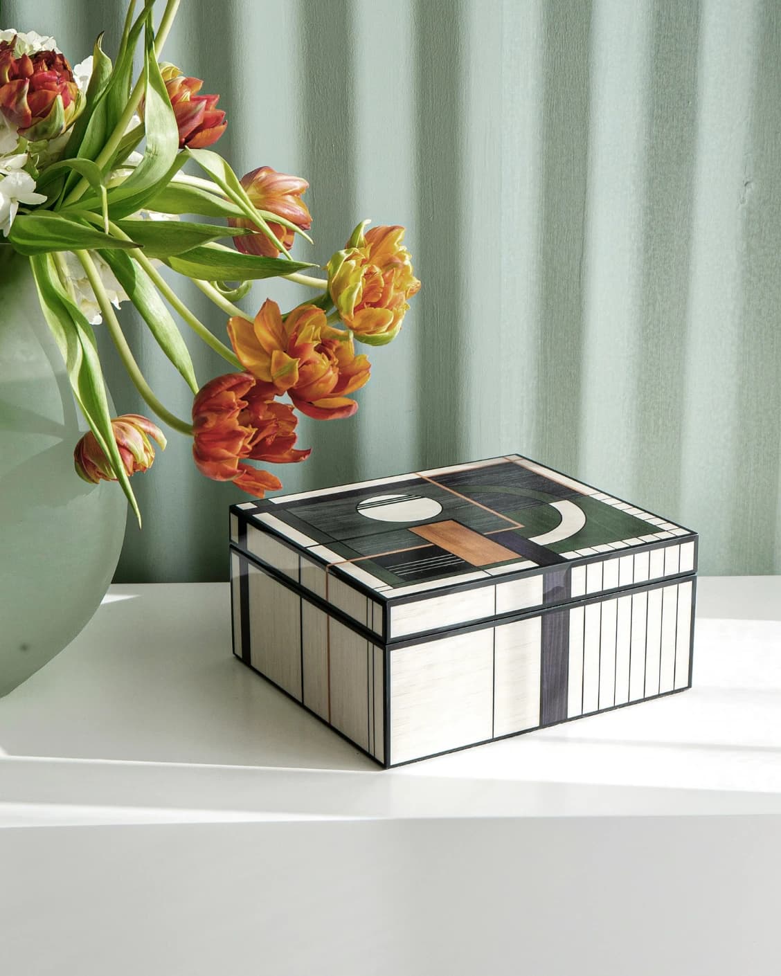 Miro Cornell accessory in black and beige, shown in a lifestyle left view as image 1