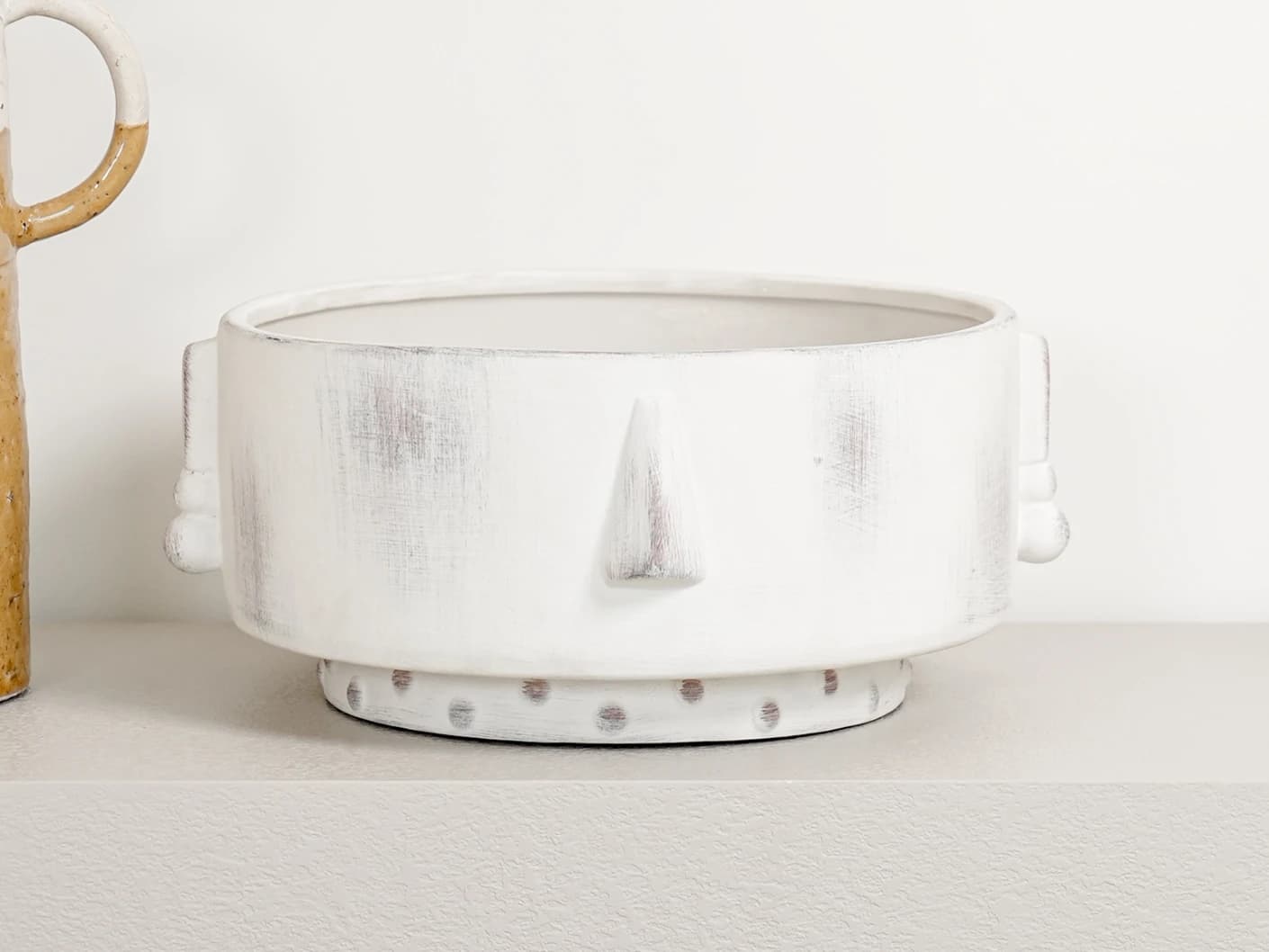 Misha Terra bowls in ivory and white, shown in a lifestyle front view