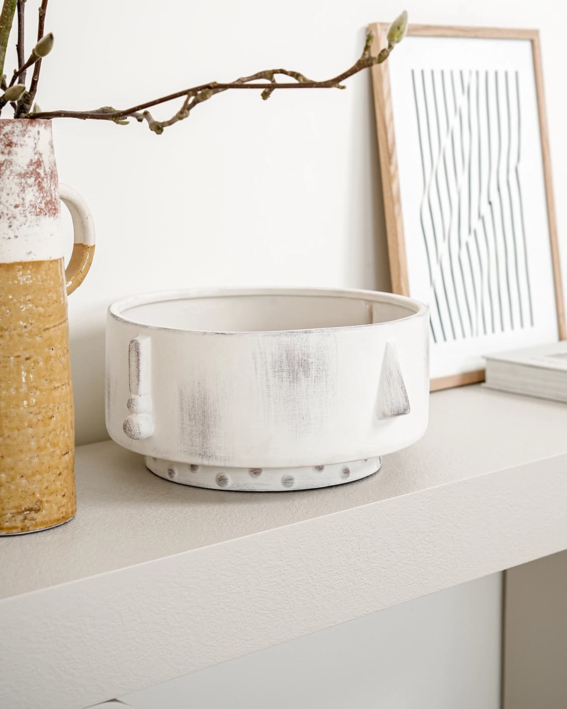 Misha Terra bowls in ivory and white, shown in a lifestyle left view as image 2