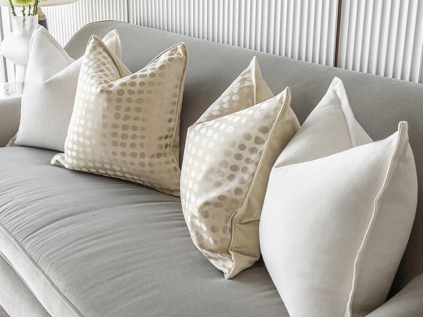 Myla Bundle bundle cushions in white, beige and gold, shown in a lifestyle front view