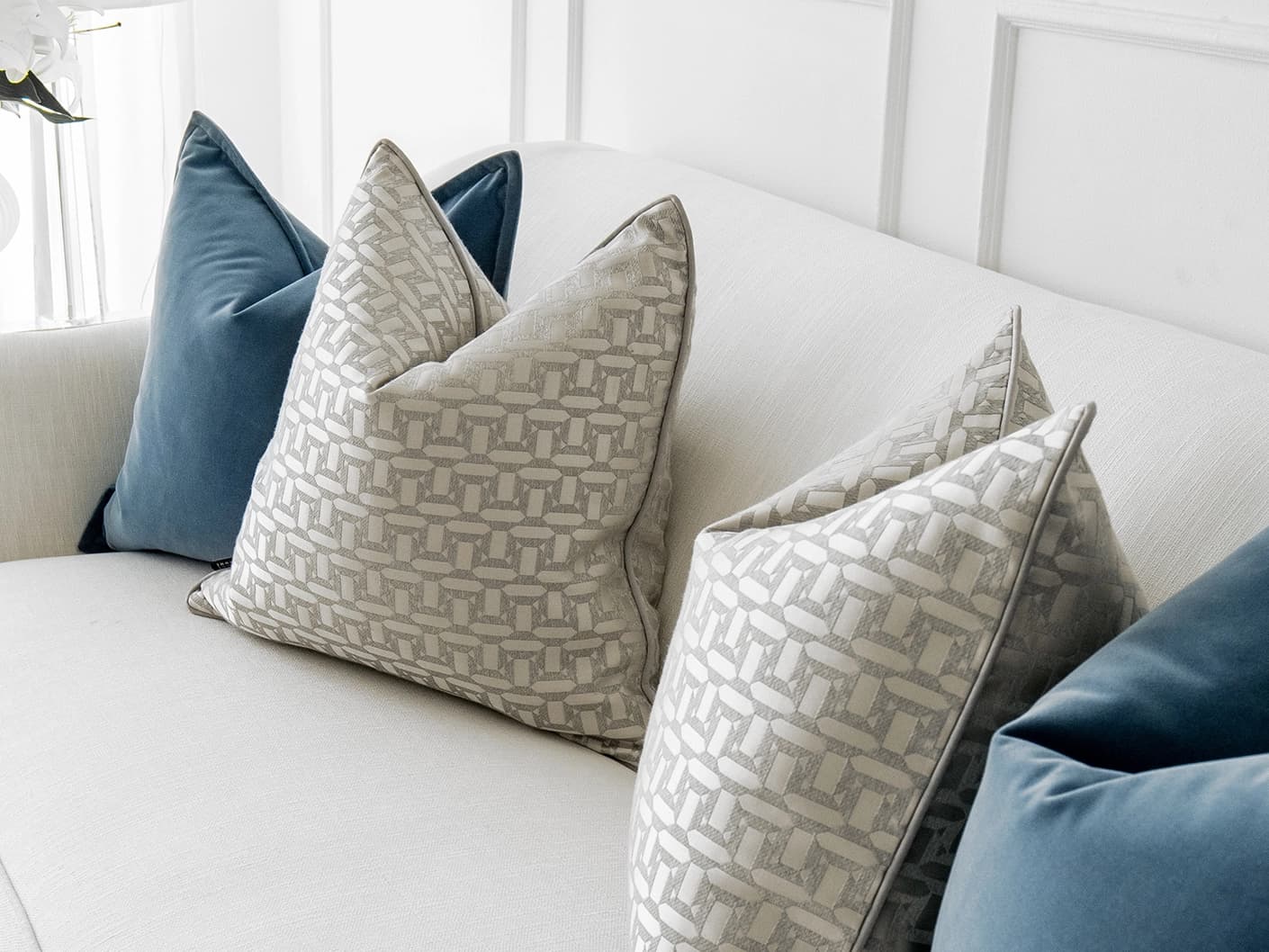 Myra Bundle bundle cushions in blue, beige and silver, shown in a lifestyle front view