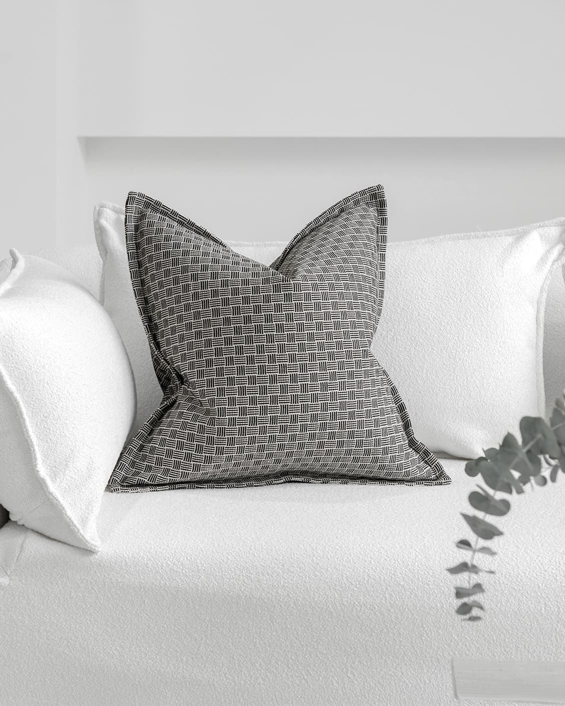 Naomi Steele cushion in grey, shown in a lifestyle front view as image 2