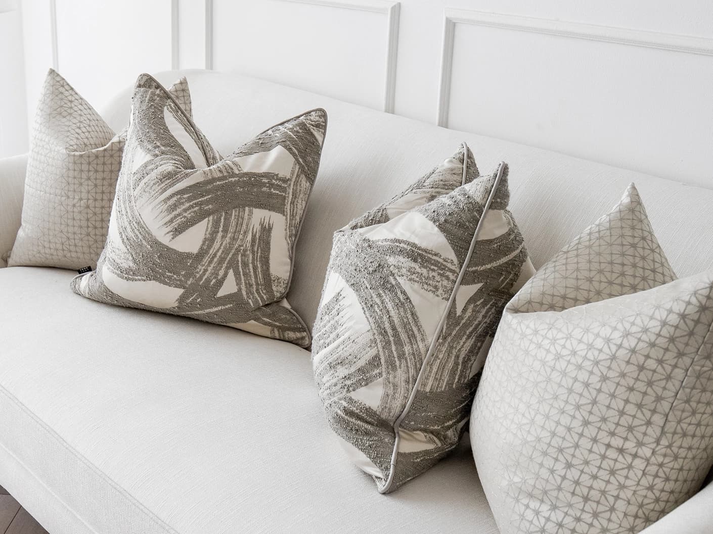 Naya Bundle bundle cushions in silver, white and grey, shown in a lifestyle front view
