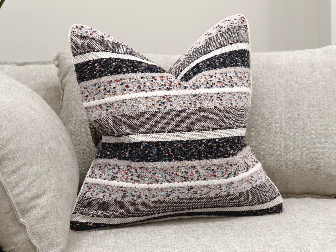 Naysa Canova single cushions in multicolour, shown in a lifestyle front view