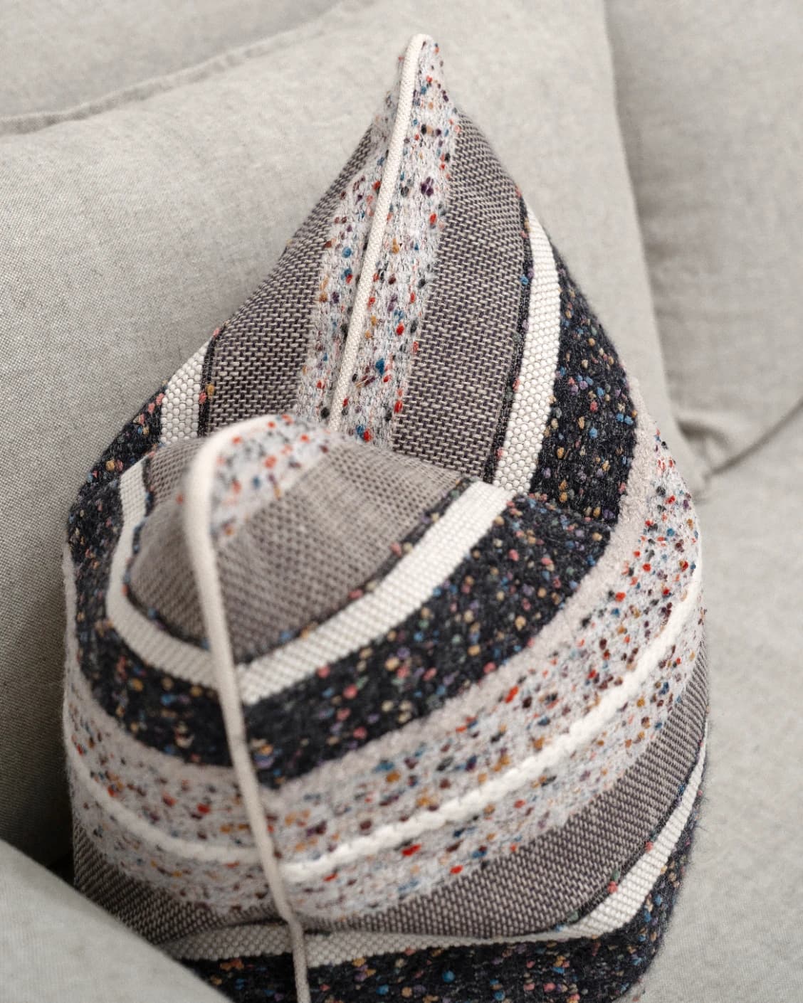 Naysa Canova cushion in multicolour, shown in a lifestyle top view as image 5