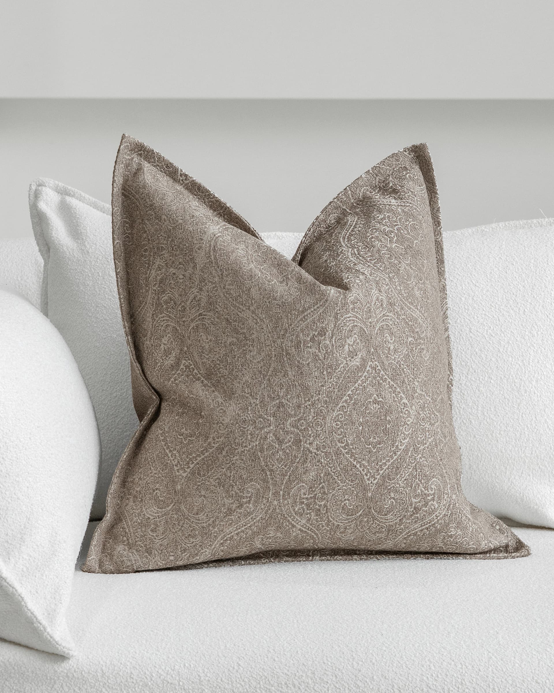Nia Laurent cushion in taupe and grey, shown in a lifestyle as image 2