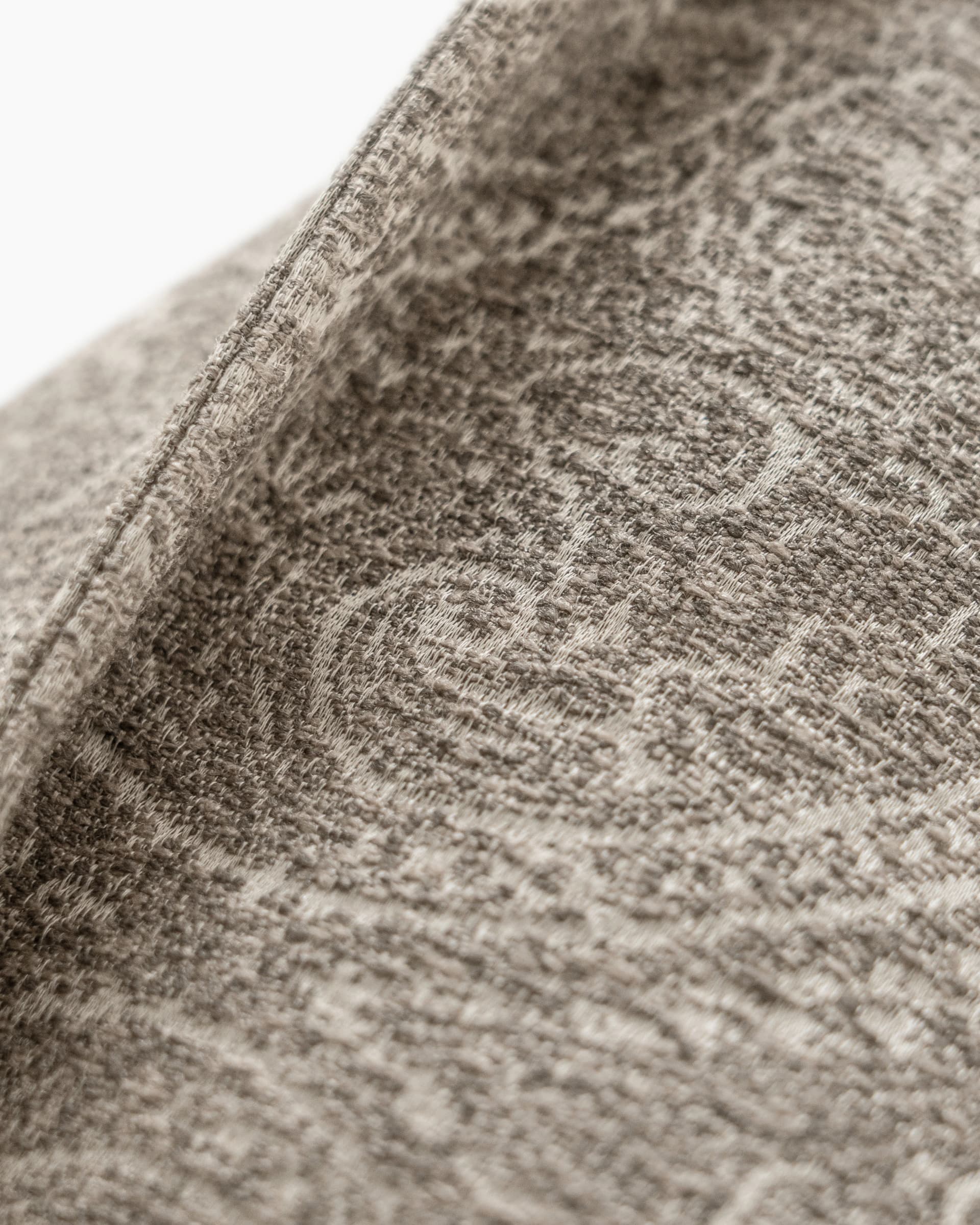 Nia Laurent cushion in taupe and grey, shown in a product left view as image 7