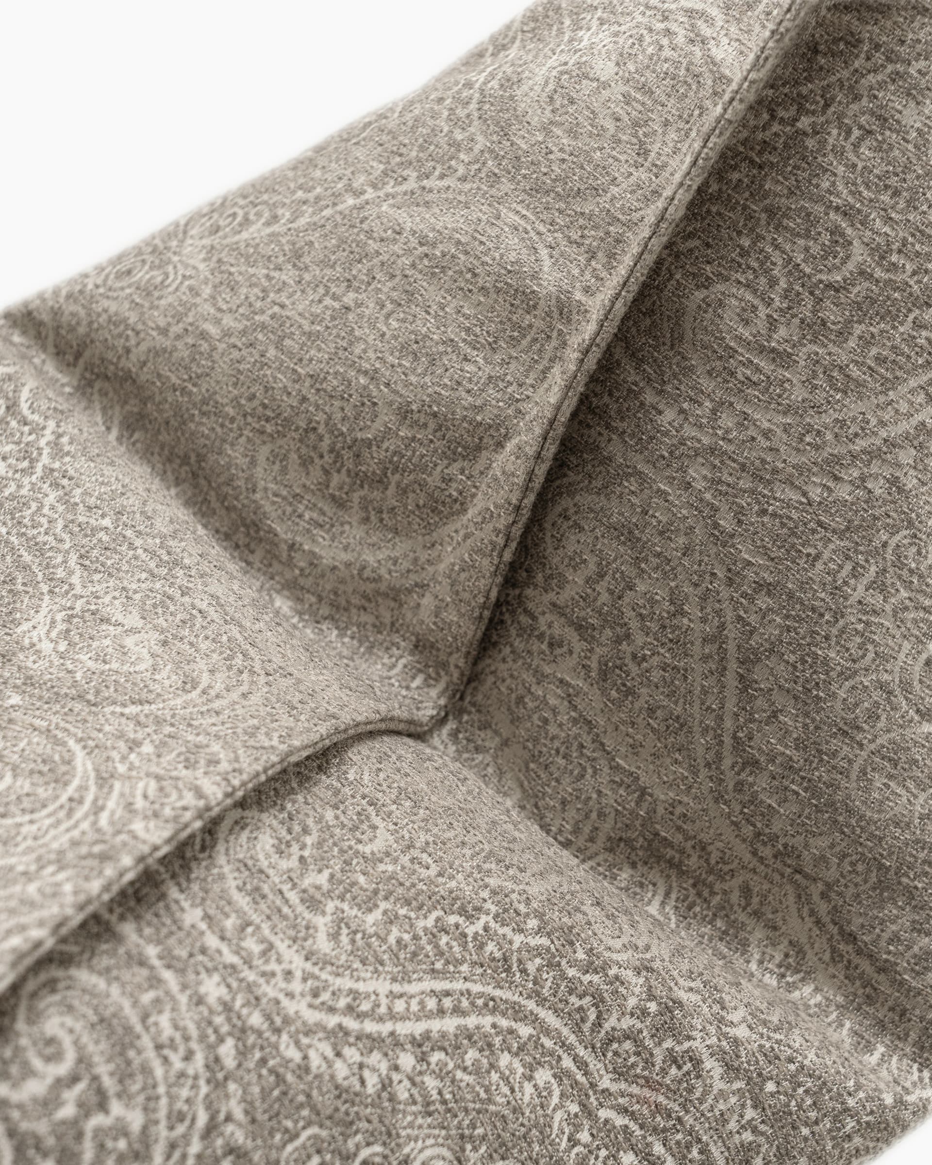 Nia Laurent cushion in taupe and grey, shown in a product top view as image 9