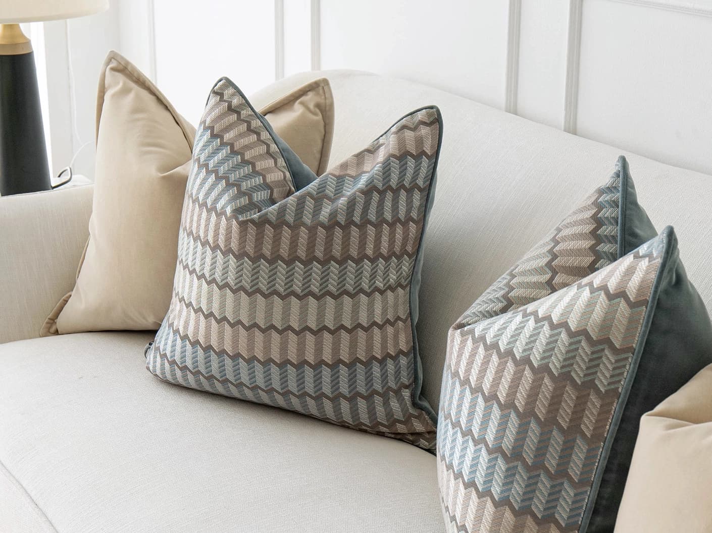 Nilla Bundle bundle cushions in silver, blue and beige, shown in a lifestyle front view