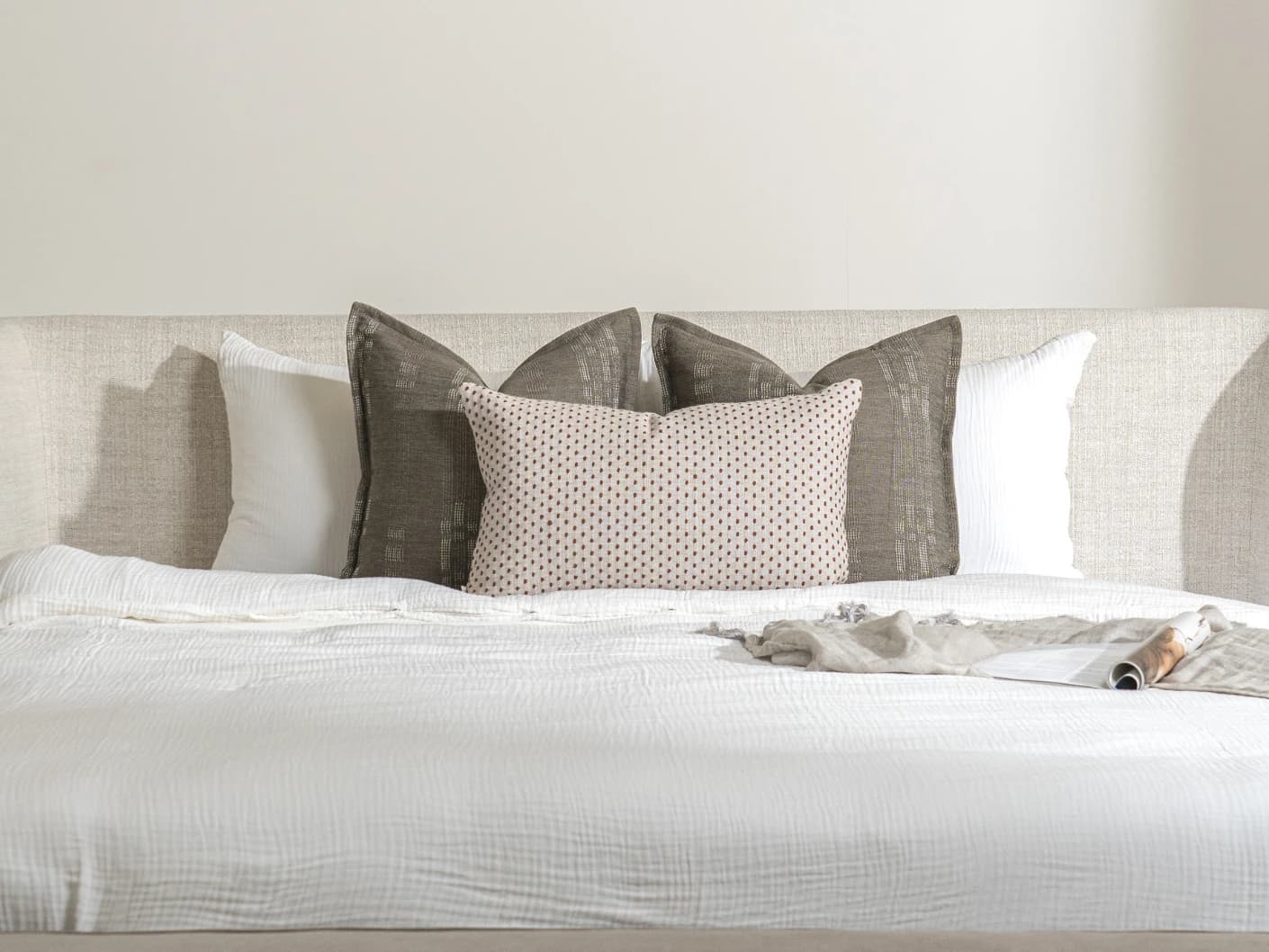 Nimitha Bundle bundle cushions in grey and beige, shown in a lifestyle front view