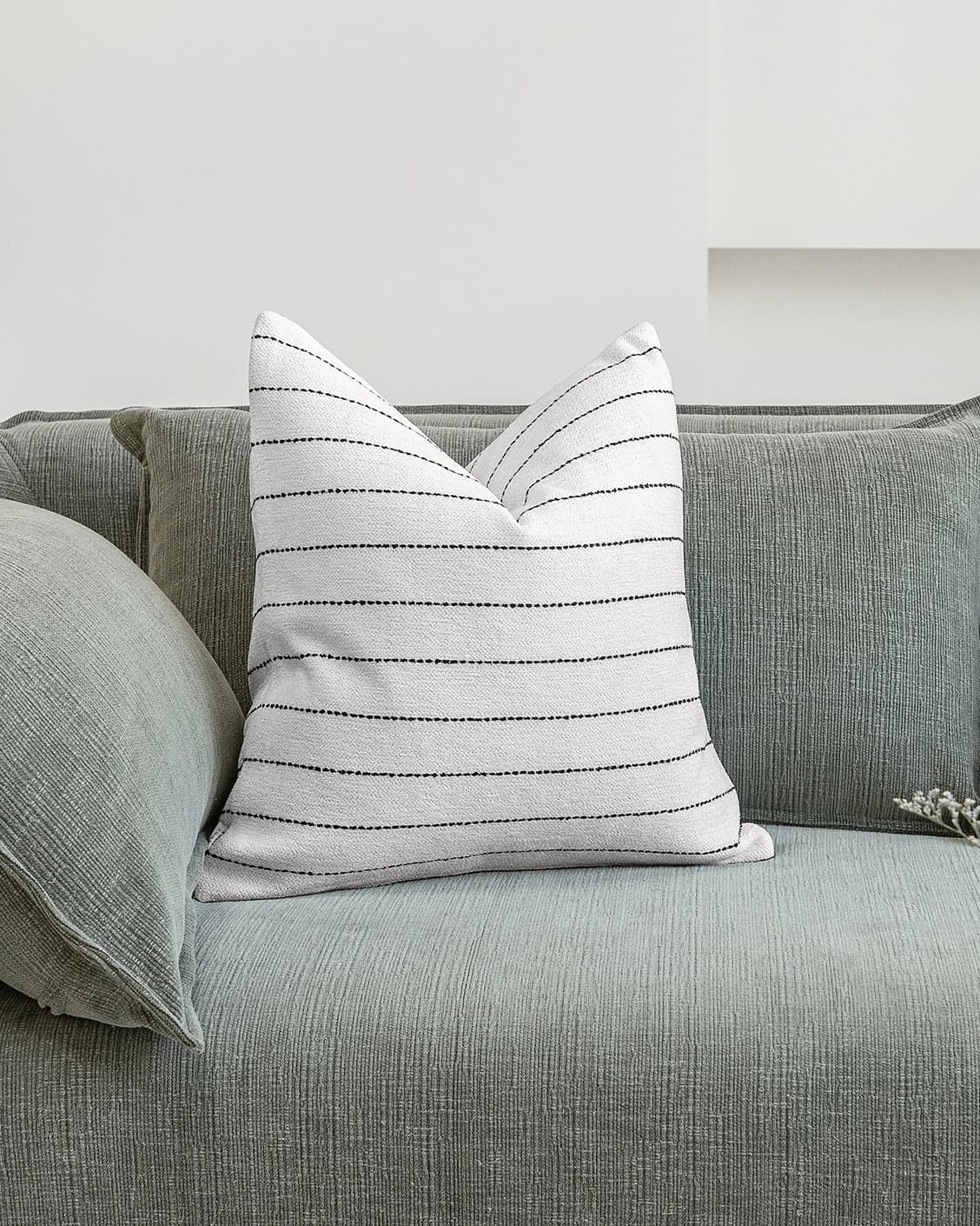 Noa Bianca cushion in black and ivory, shown in a lifestyle front view as image 2