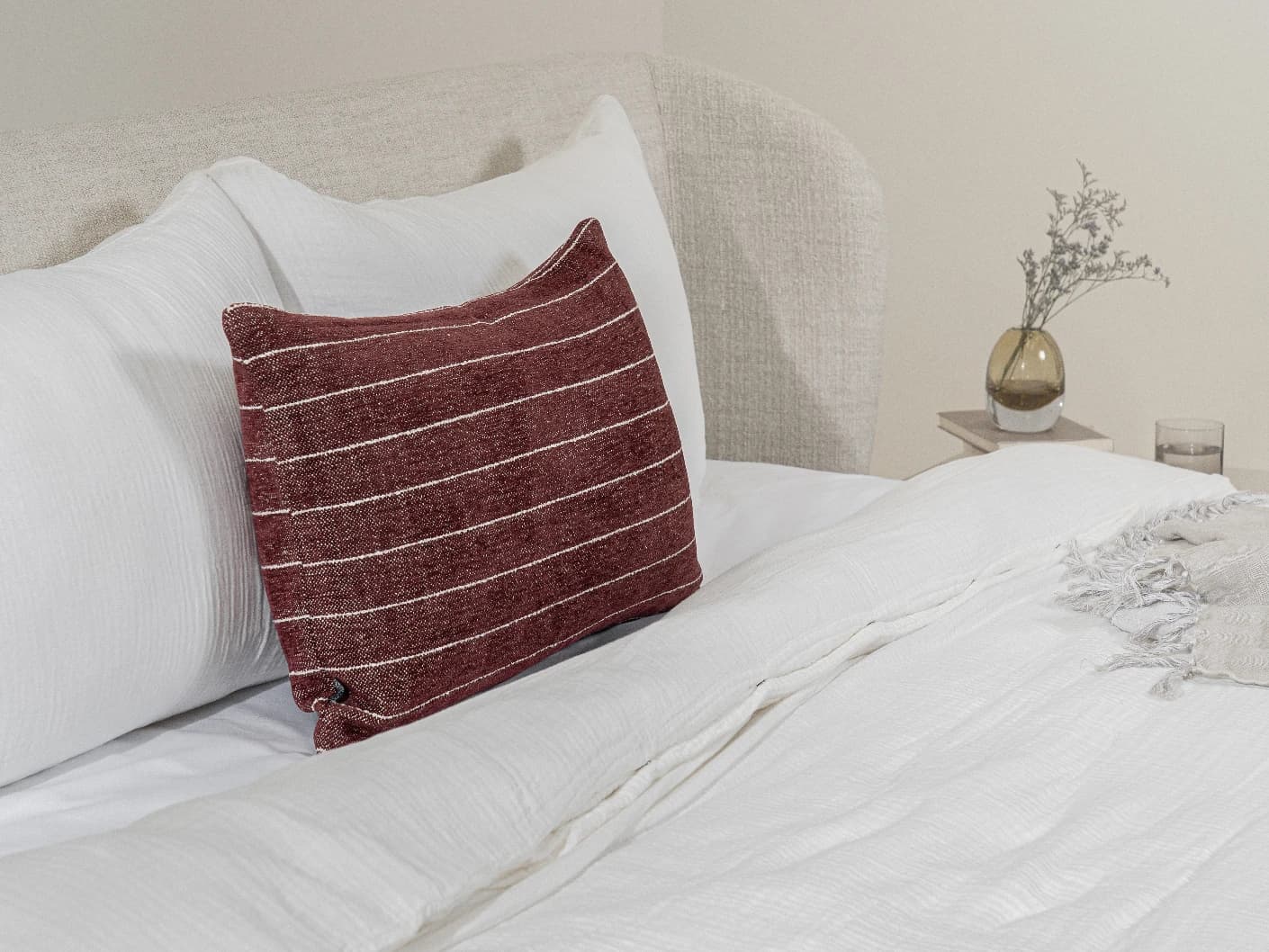 Noa Scarlet III single cushions in burgundy, shown in a lifestyle left view