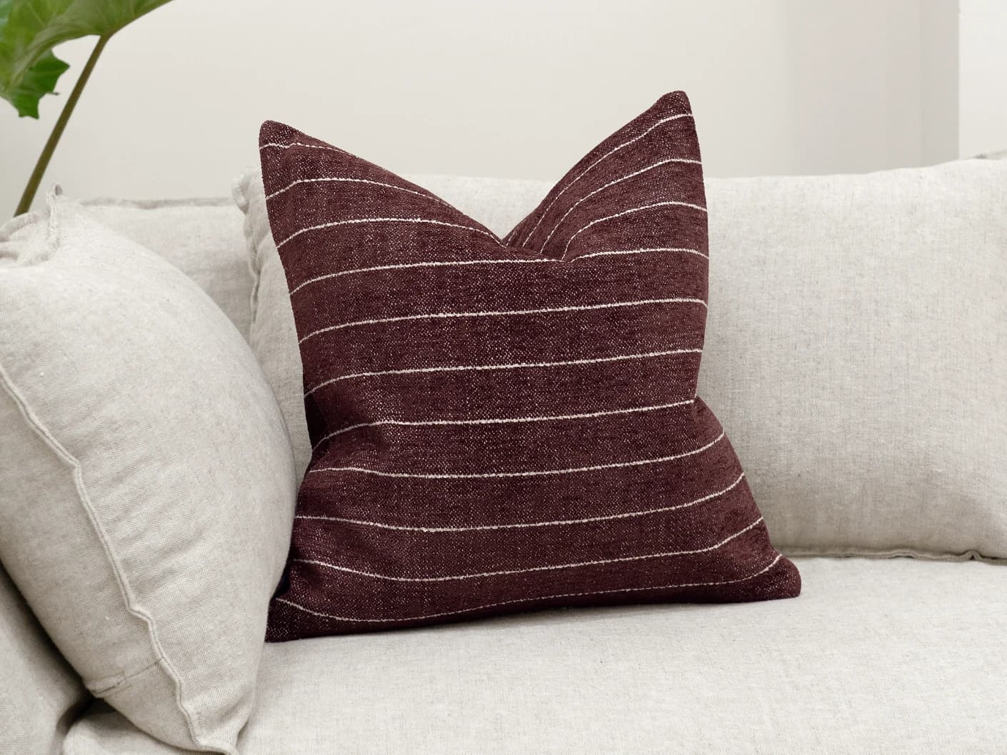 Noa Scarlet single cushions in white and red, shown in a lifestyle front view