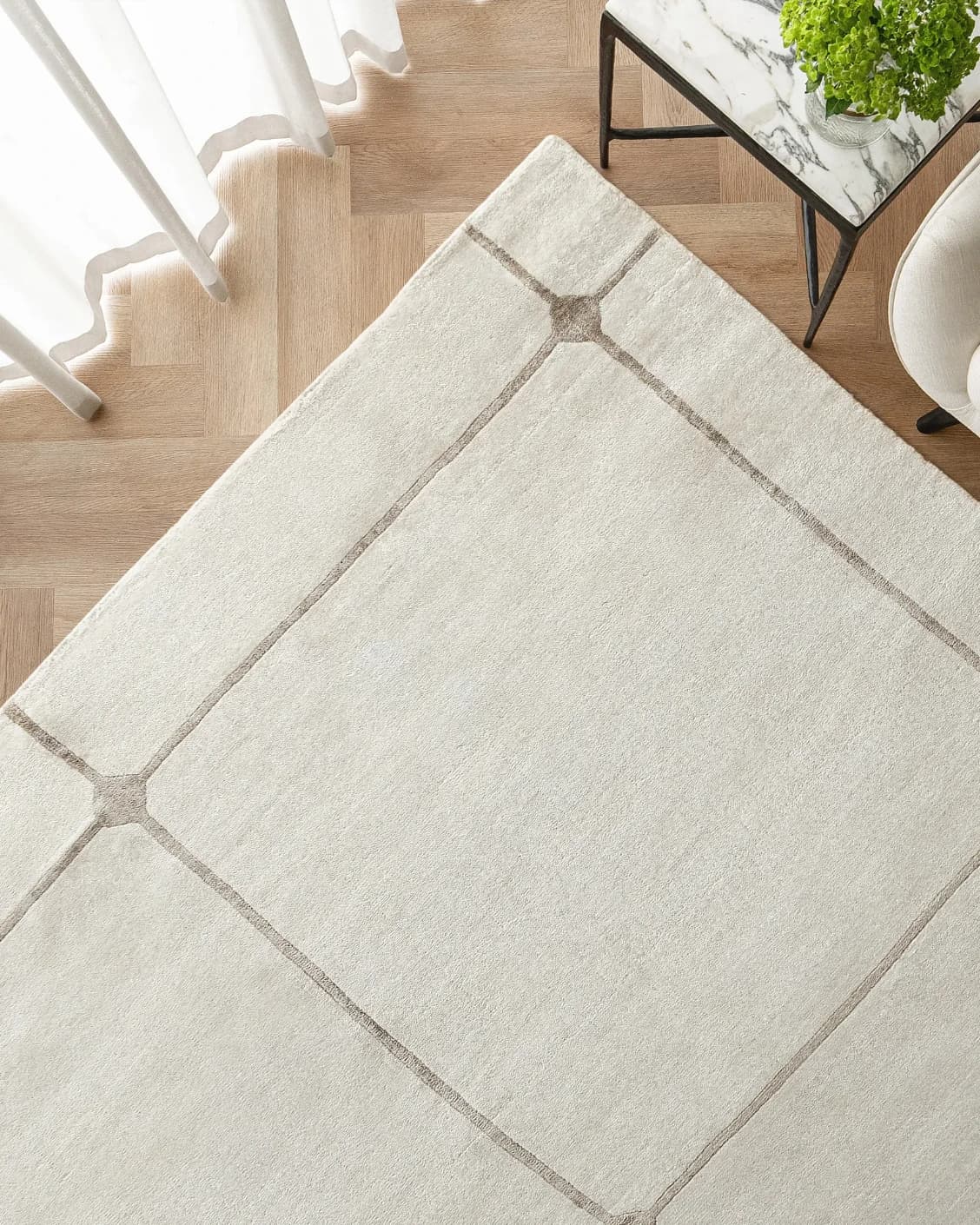 Noon Sadaf carpet in beige, shown in a lifestyle top view as image 2