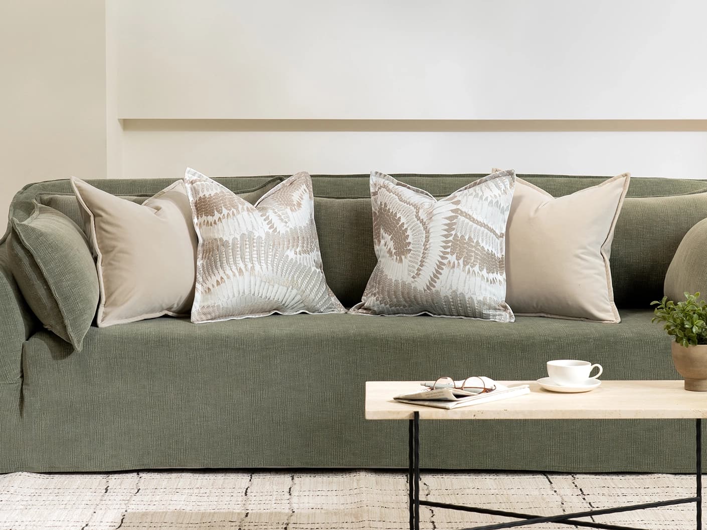 Nora Bundle cushion in beige, brown and grey, shown in a lifestyle front view as image 4