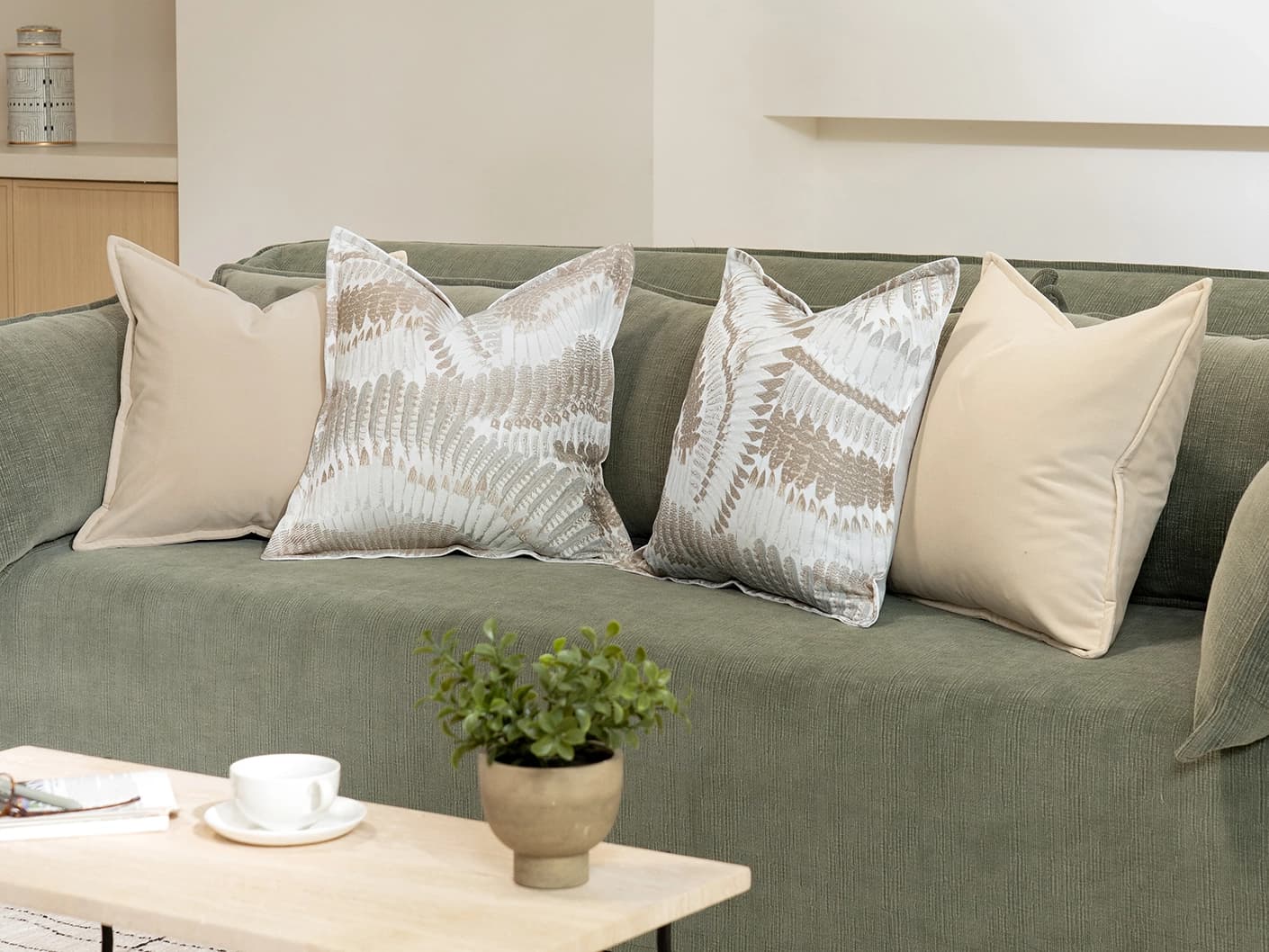 Nora Bundle bundle cushions in beige, brown and grey, shown in a lifestyle front view