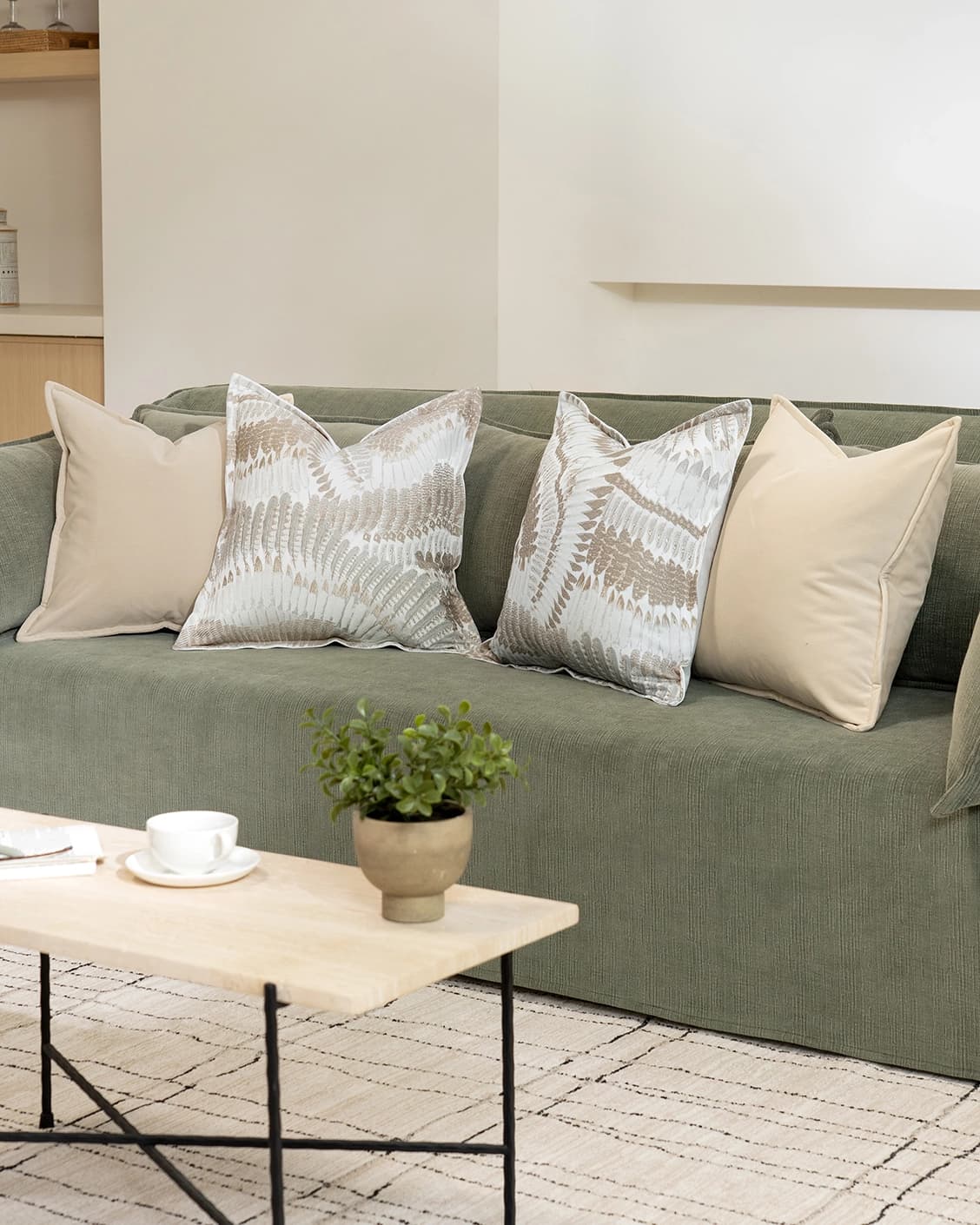 Nora Bundle cushion in beige, brown and grey, shown in a lifestyle right view as image 2