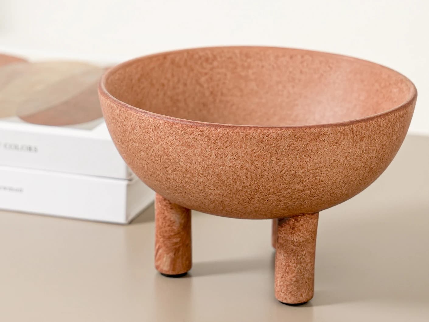 Nuva Terra bowls in orange, shown in a lifestyle front view