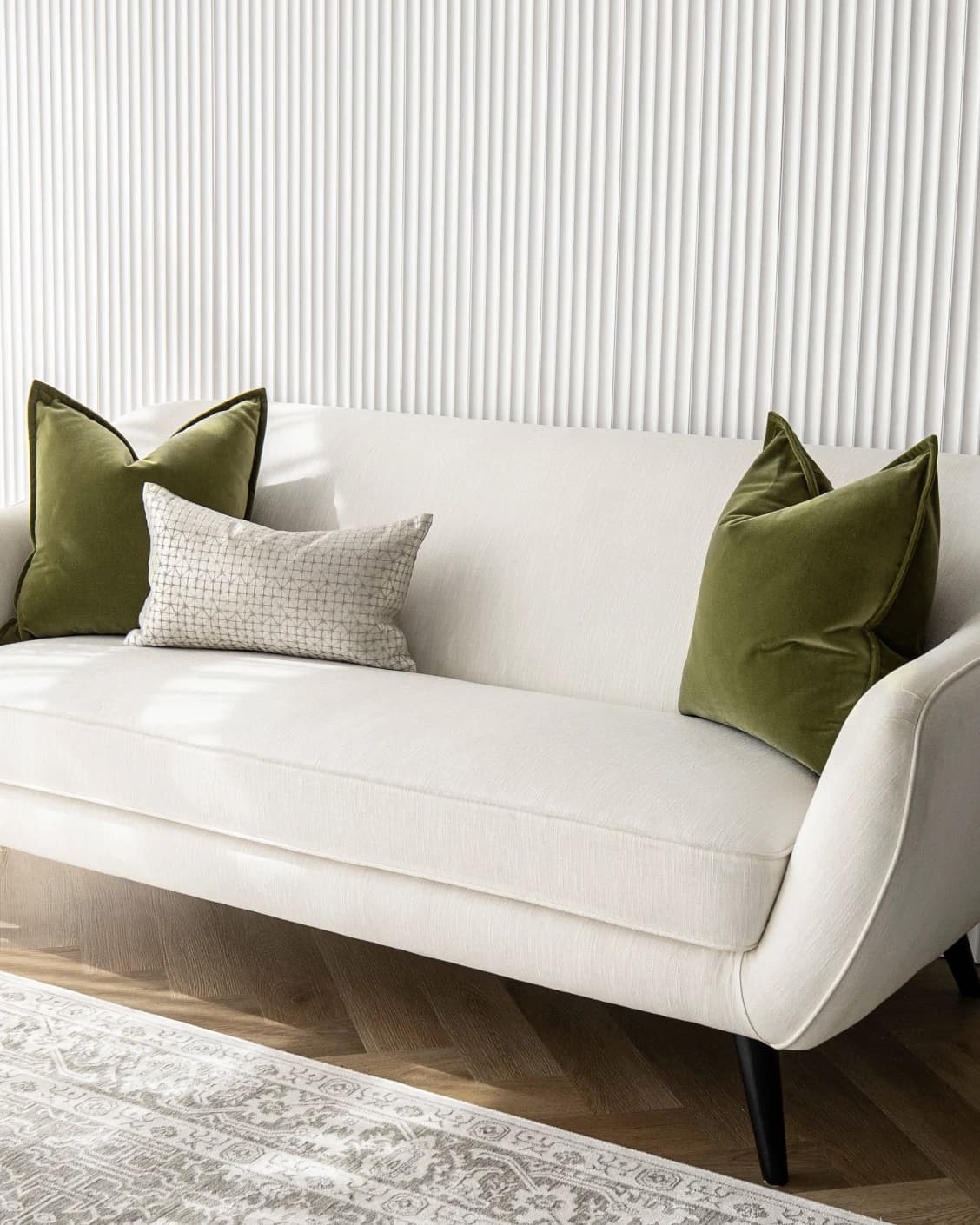 Oakley Bundle cushion in silver, green and white, shown in a lifestyle front view as image 2