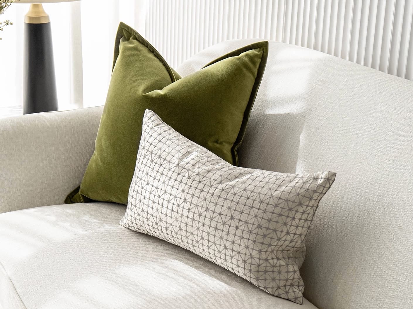 Oakley Bundle bundle cushions in silver, green and white, shown in a lifestyle front view