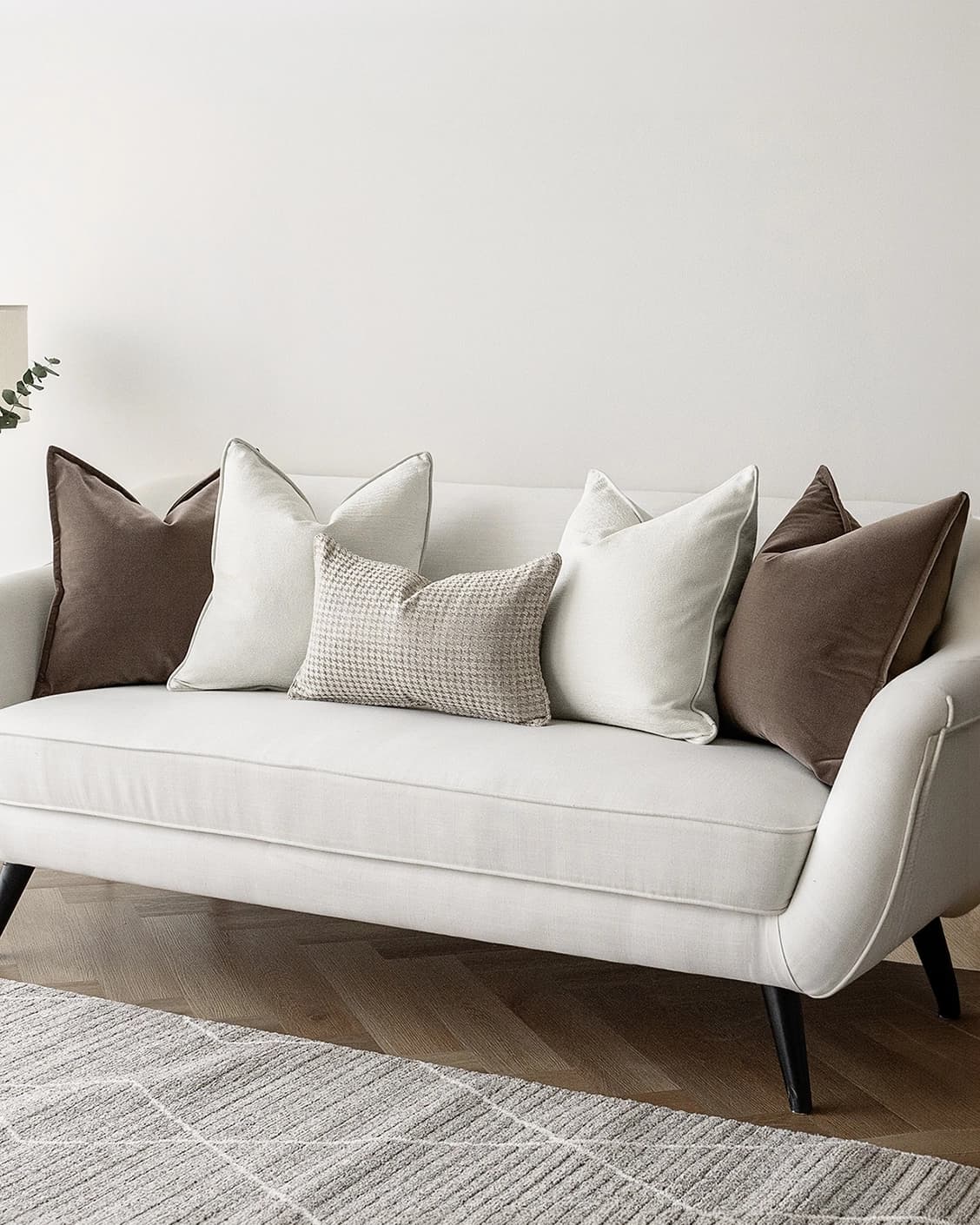Oliver Bundle cushion in brown, white and silver, shown in a lifestyle right view as image 2