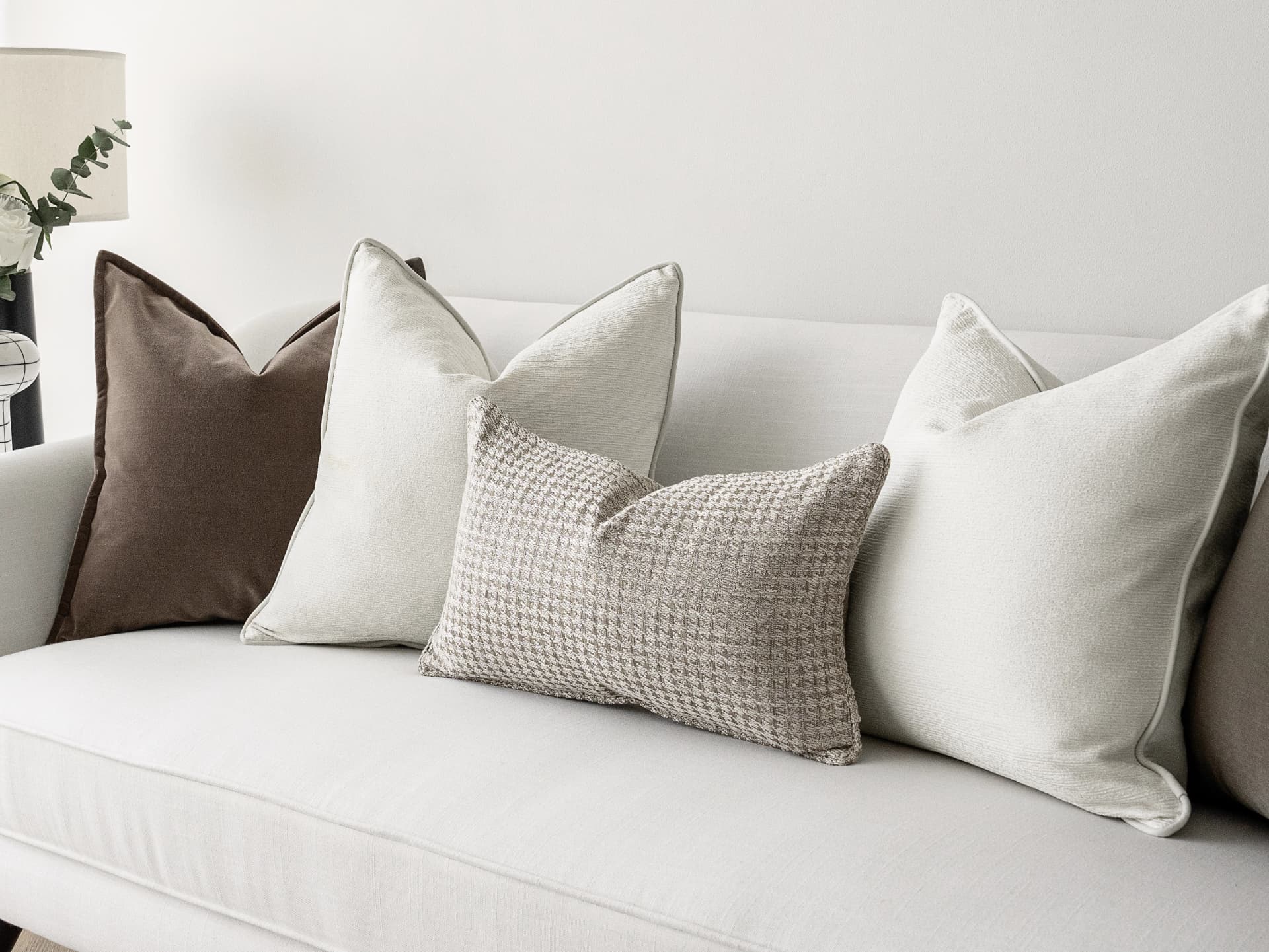 Oliver Bundle bundle cushions in brown, white and silver, shown in a lifestyle front view