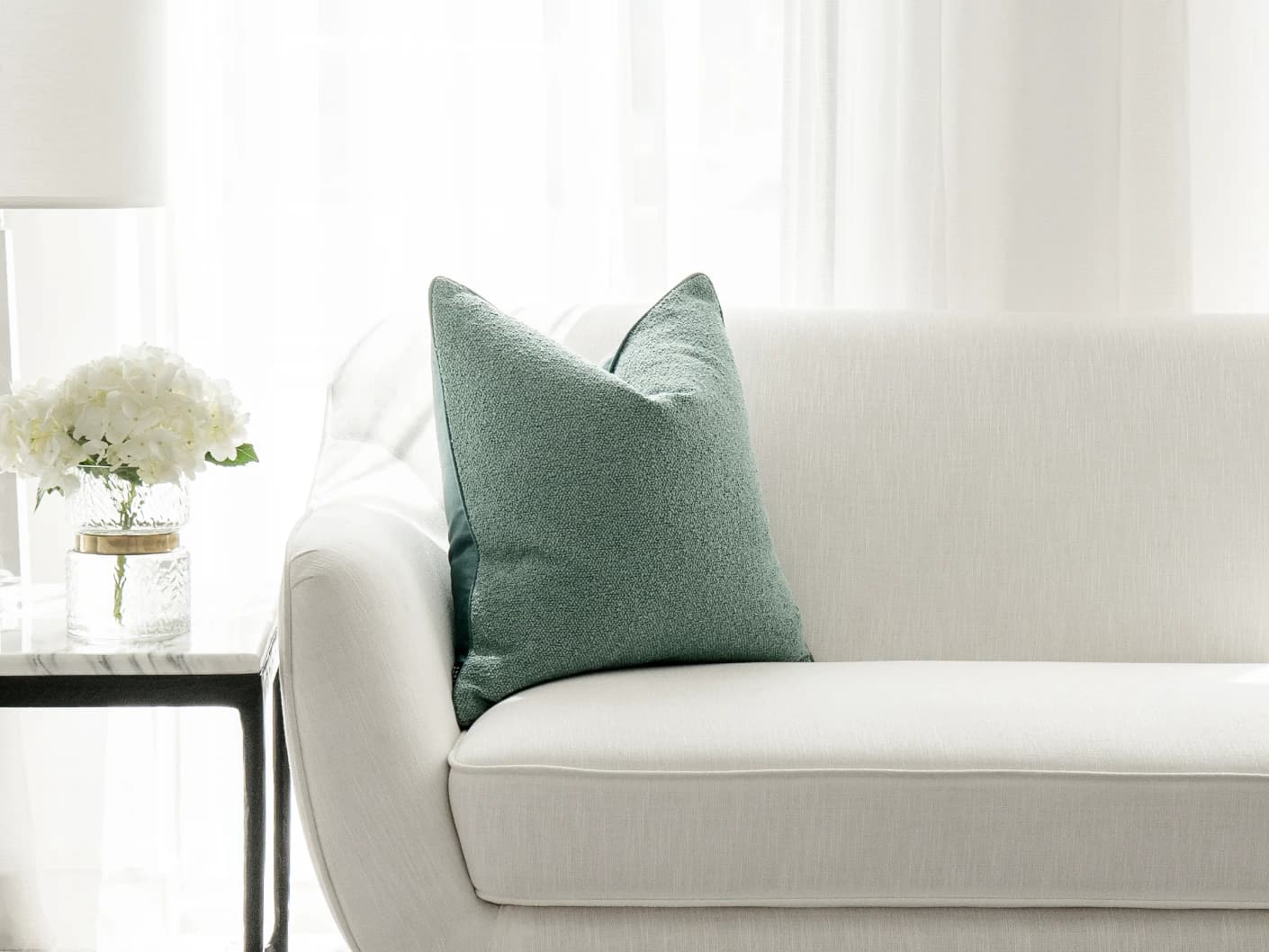 Oliver Sage single cushions in green, shown in a lifestyle front view