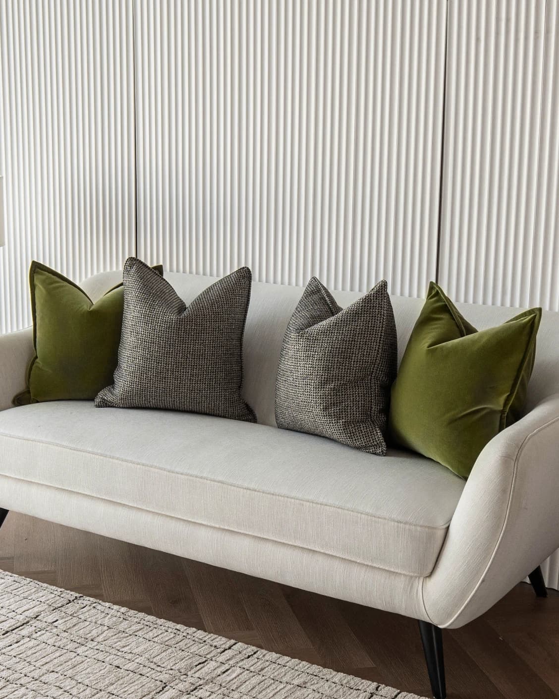 Olympia Bundle cushion in green and black, shown in a lifestyle front view as image 2