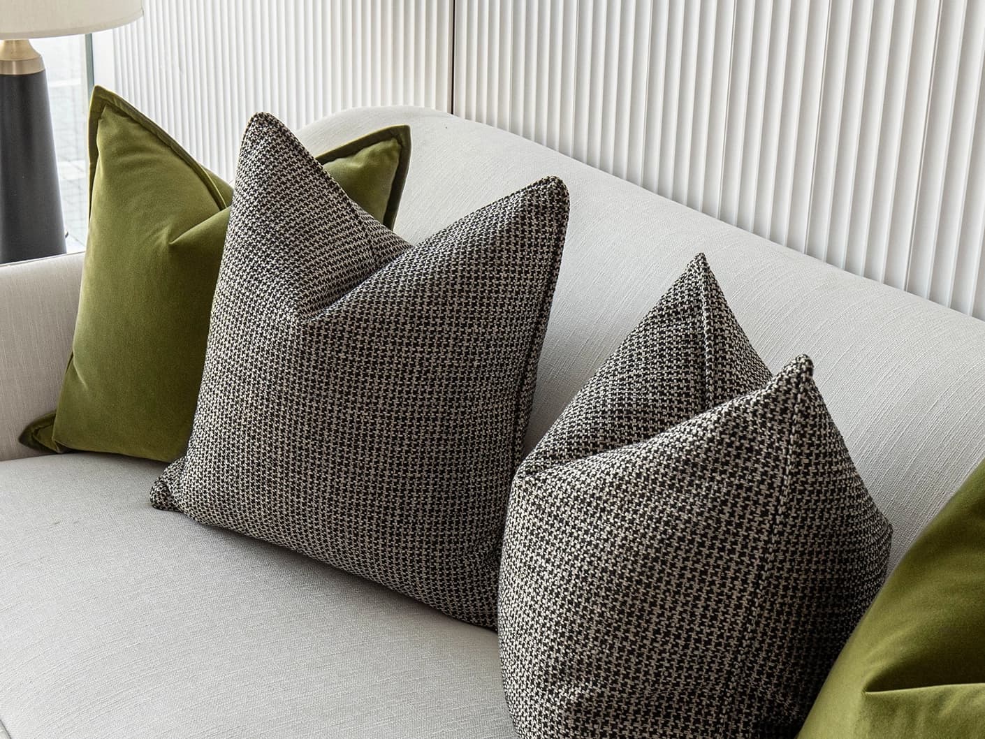 Olympia Bundle bundle cushions in green and black, shown in a lifestyle front view