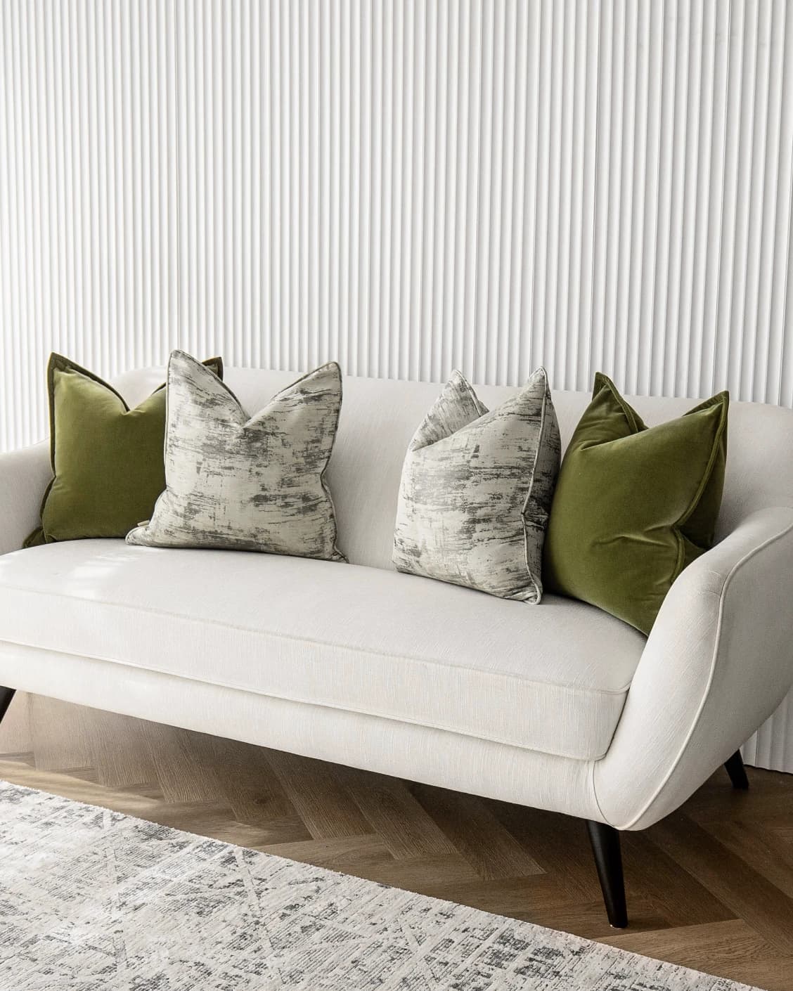 Omarie Bundle cushion in green, grey and white, shown in a lifestyle front view as image 2